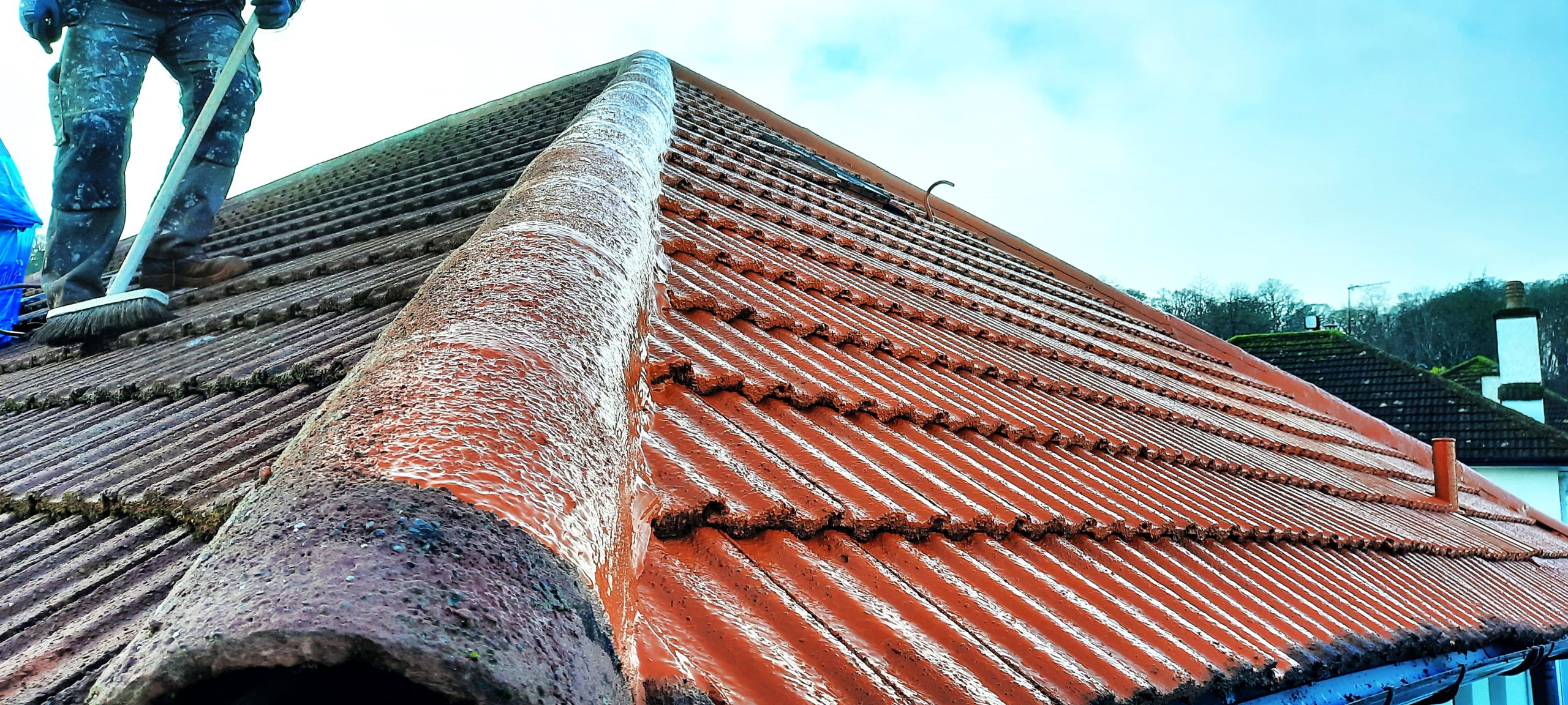 roughcasting Edinburgh at roof ridge with visible moss removal