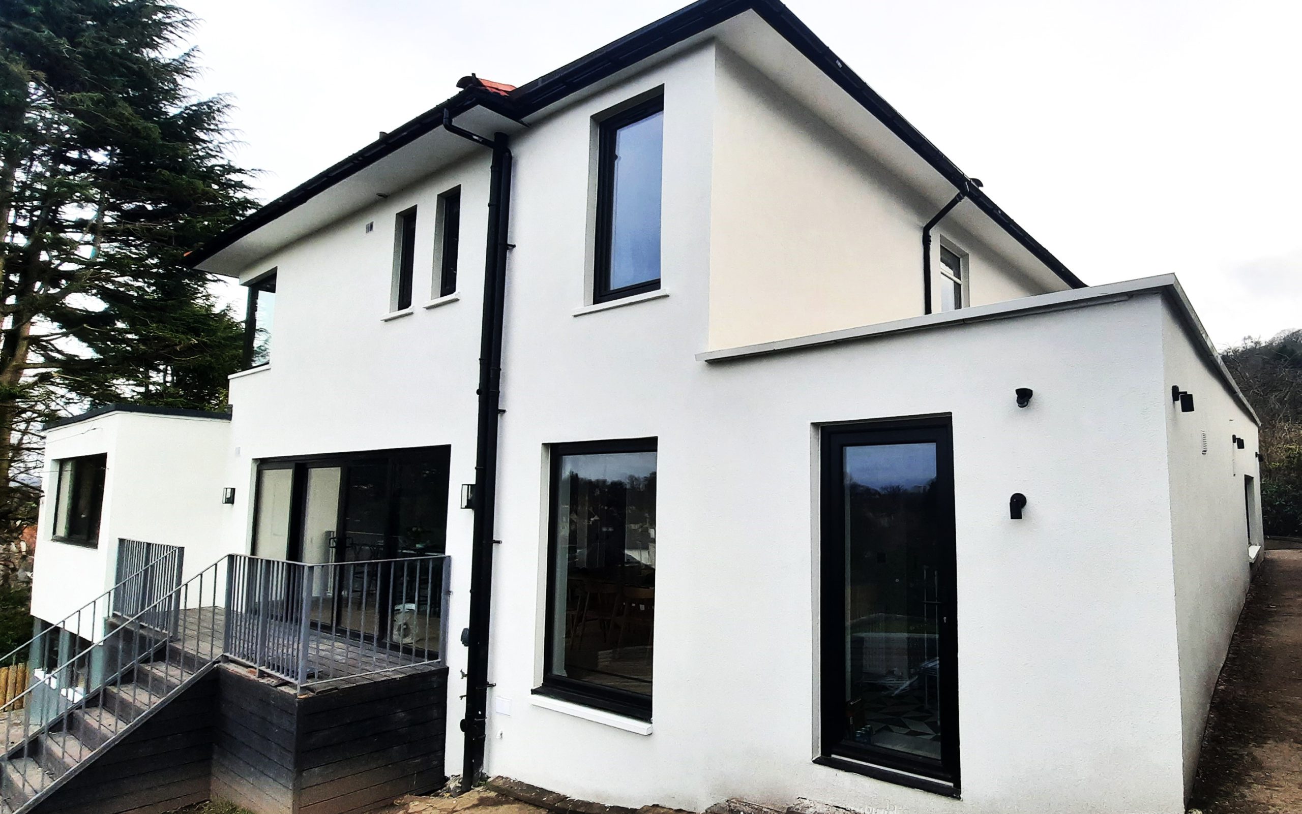 Rendering Edinburgh on modern white home with black garage door