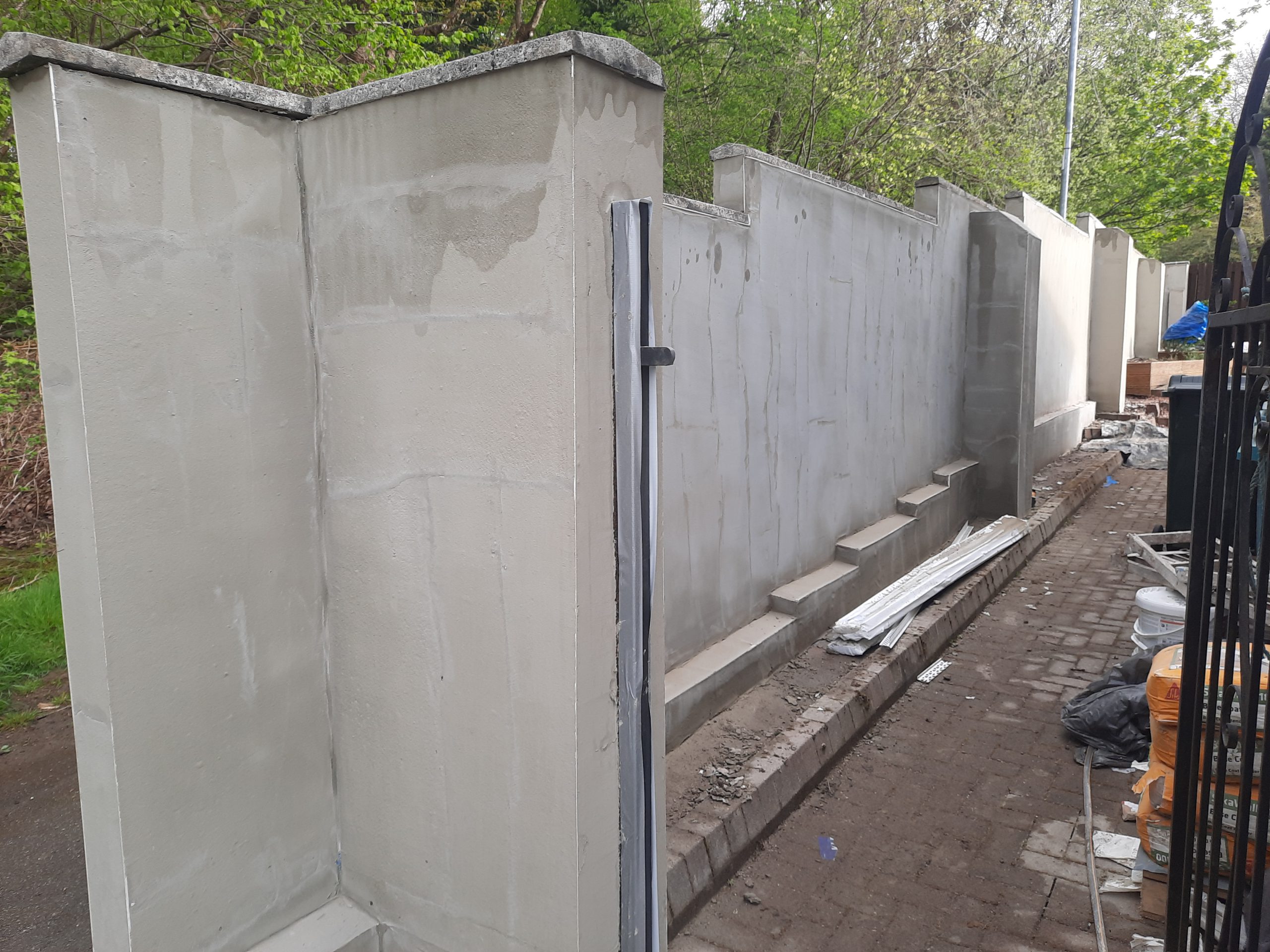 roughcast render repair partly applied to garden wall