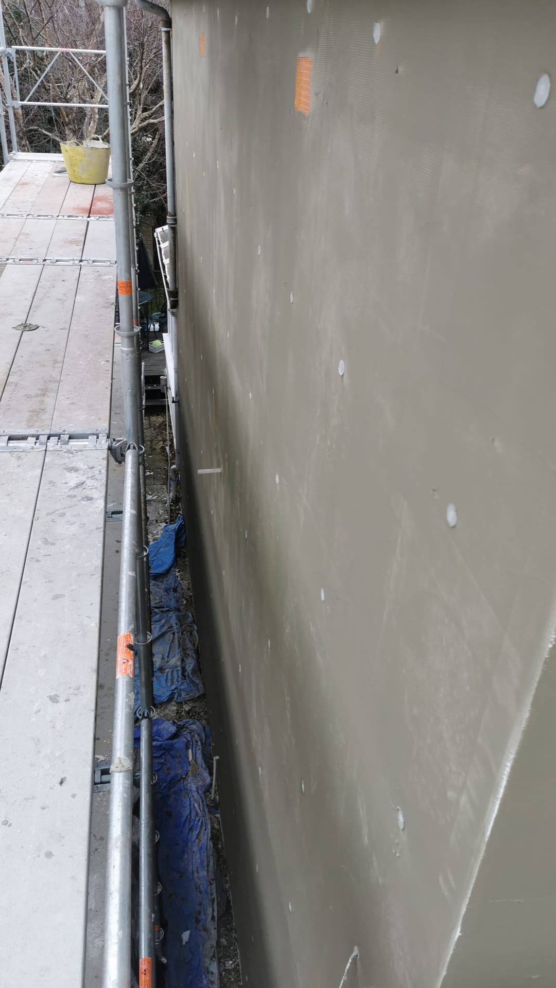Insulation Edinburgh beneath render layer by roof gutter