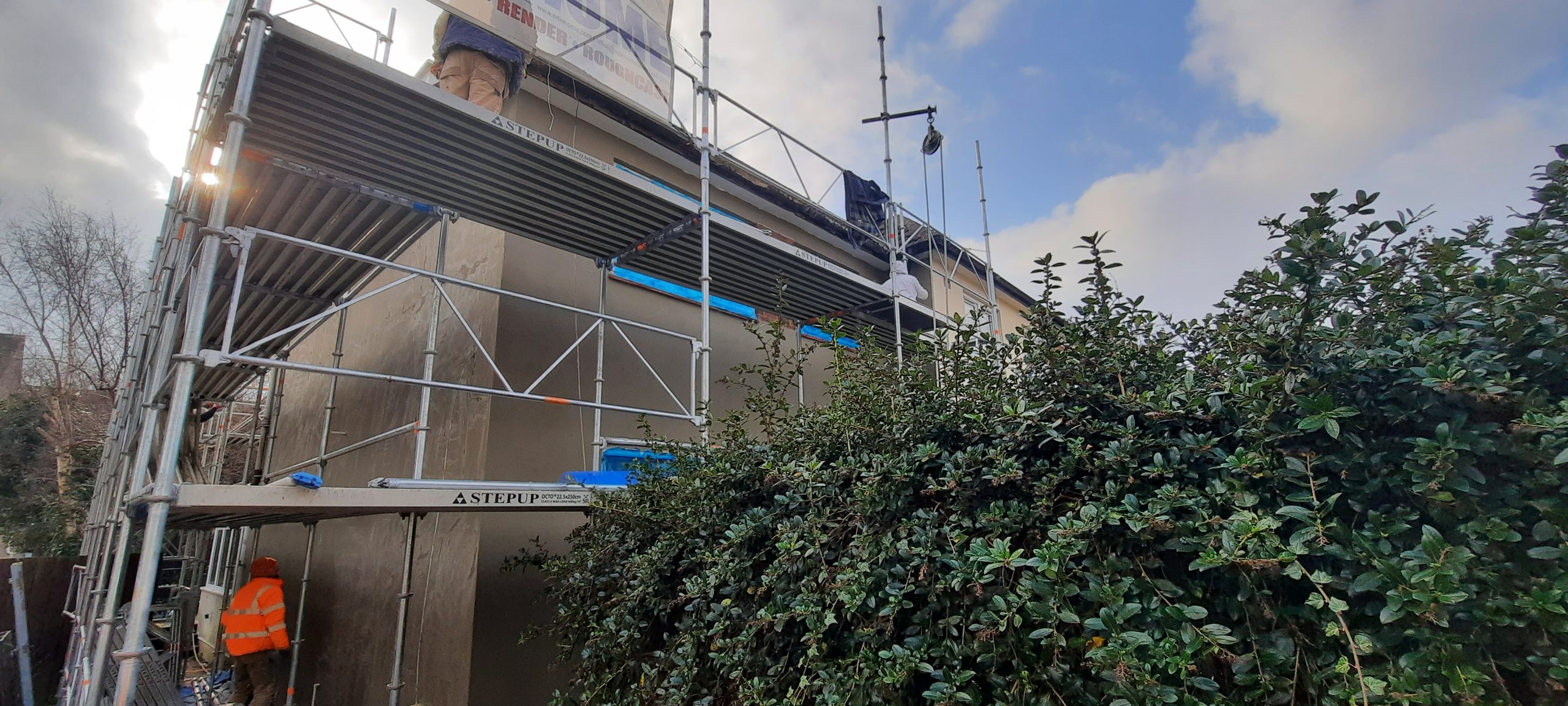 roughcast repair on high scaffolded gable wall