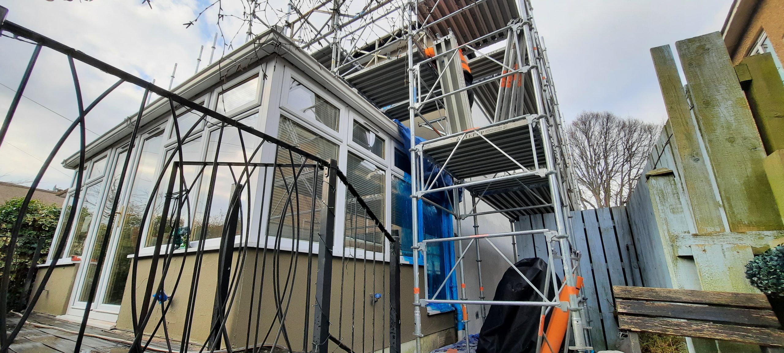 roughcast render repair above glass front porch