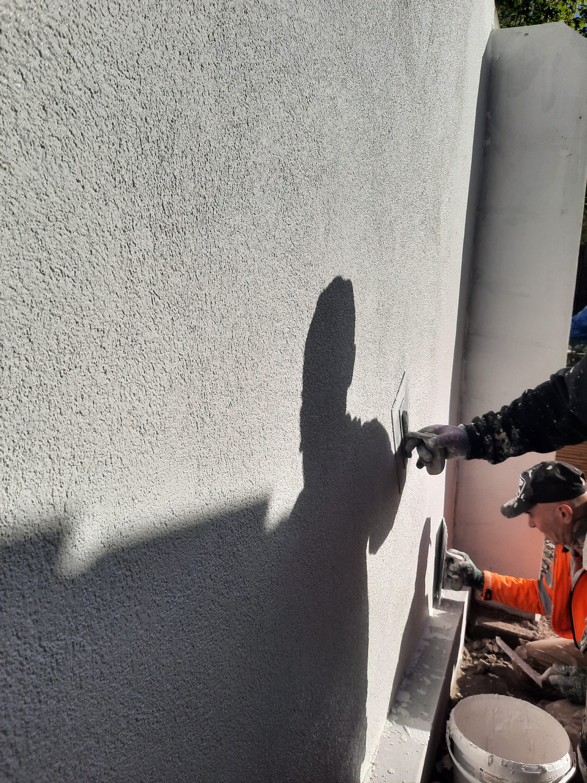 roughcast render repair by spray application on exterior wall