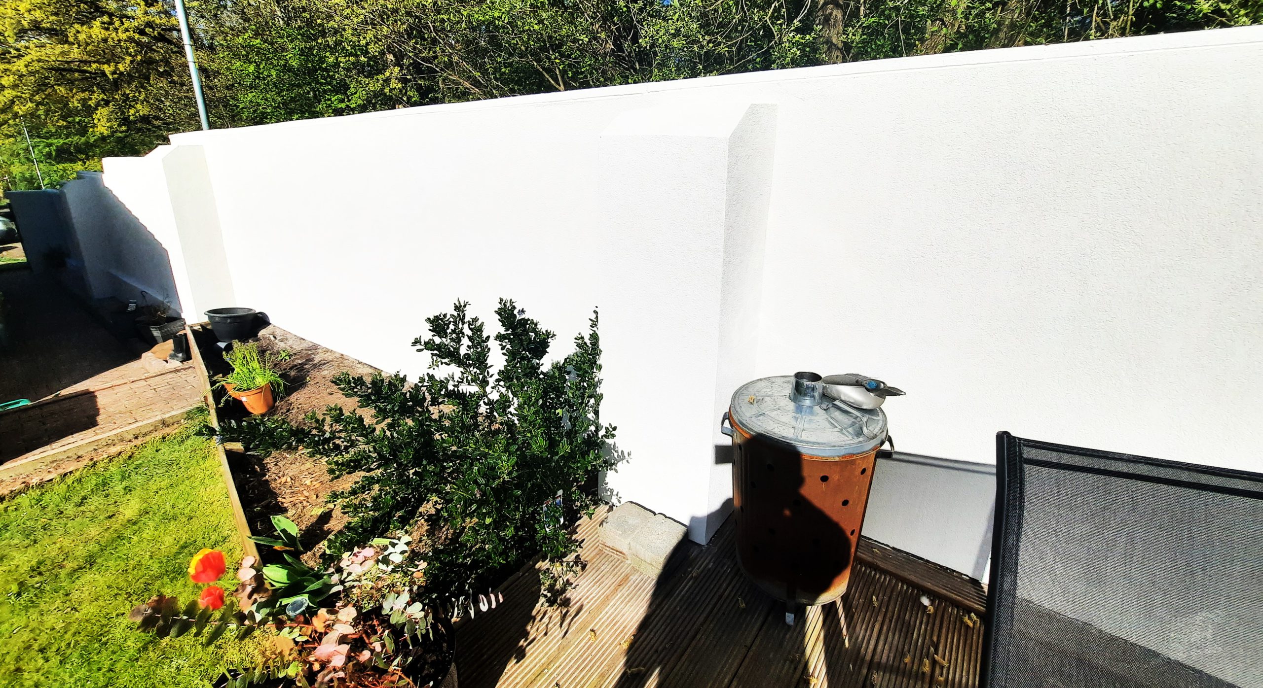 roughcasting Edinburgh on bright white boundary wall
