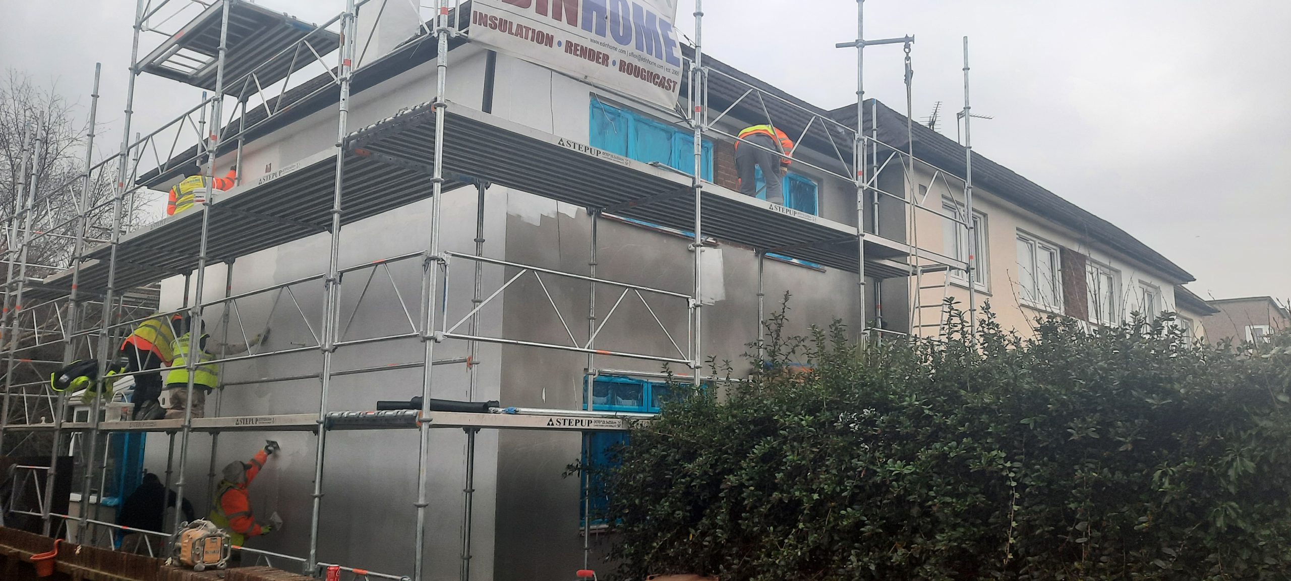 roughcast render repair under scaffolding on front façade