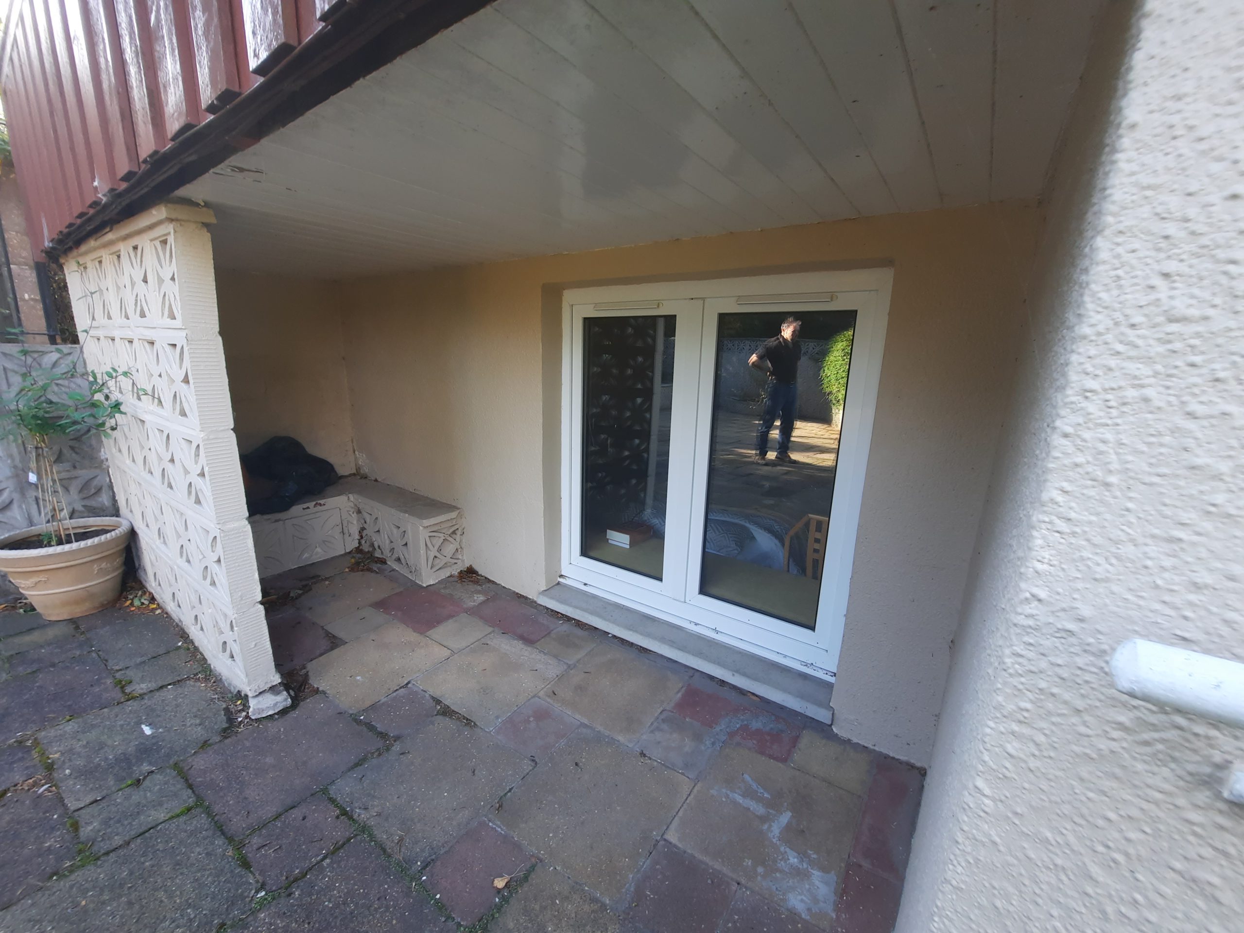 roughcaster Edinburgh working on white patio entrance wall
