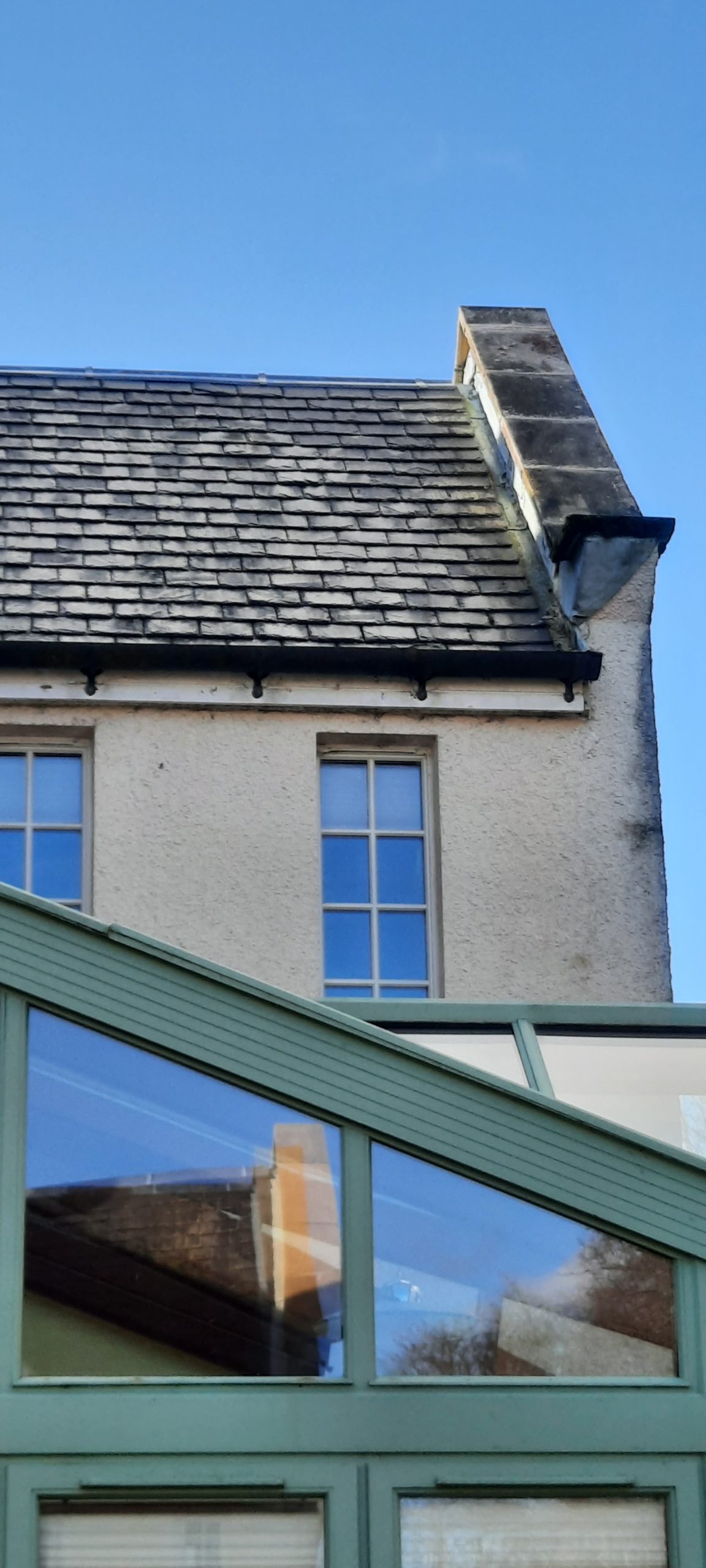 Rendering Edinburgh on roofline area beside stone chimney