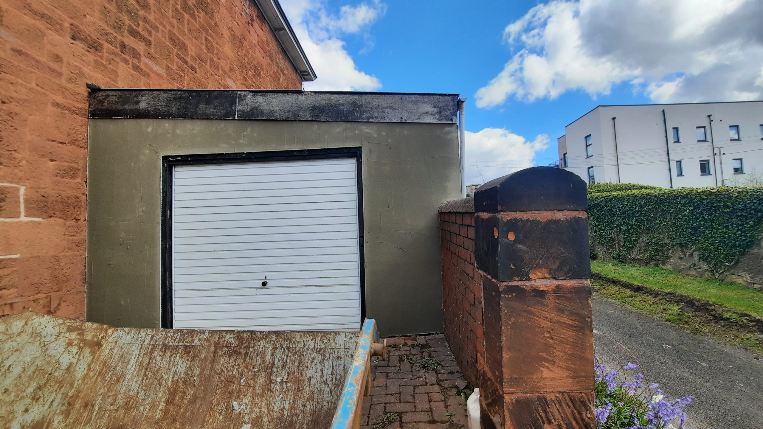 house rendering Edinburgh on garage wall with white door