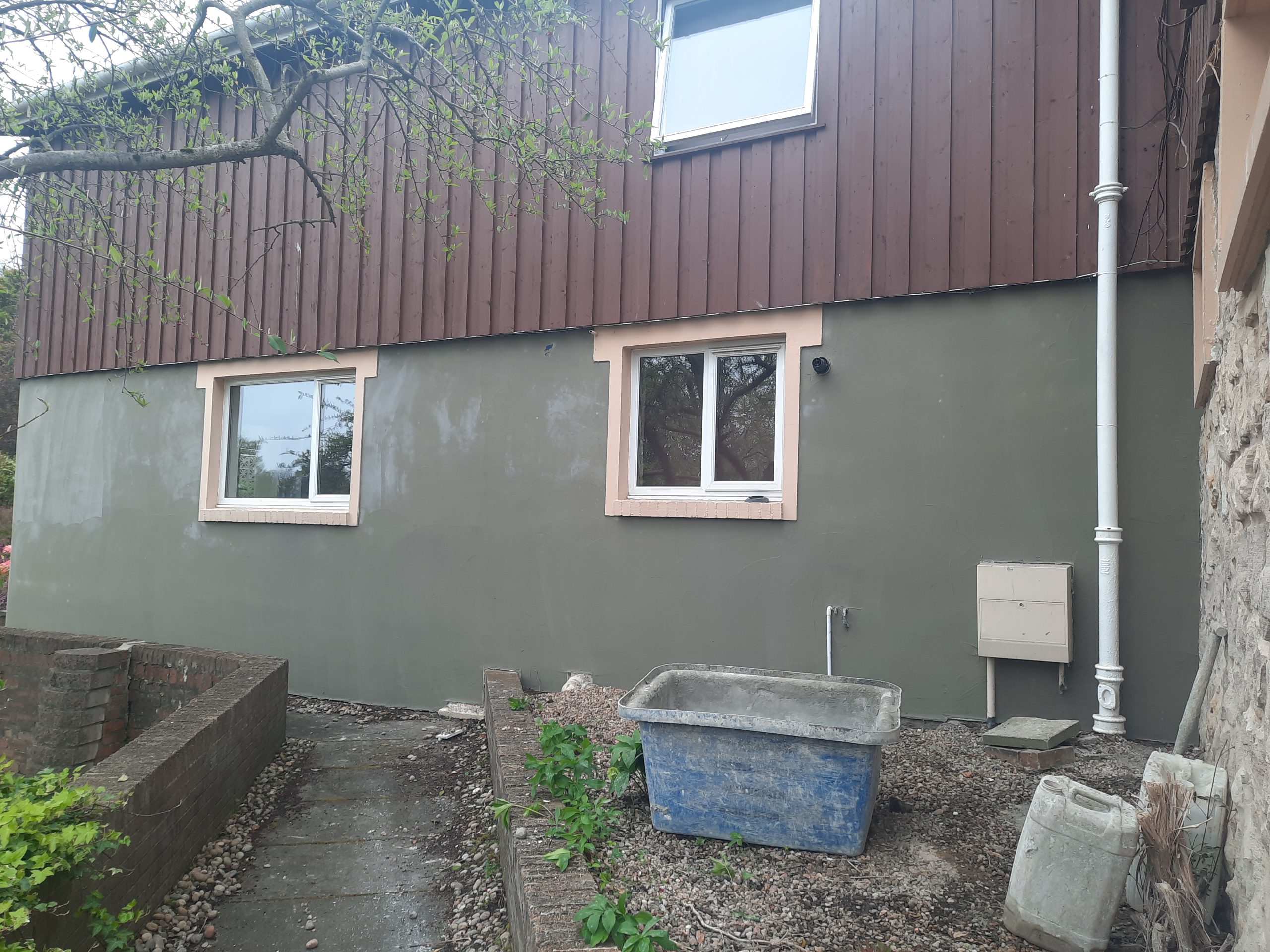 roughcast render repair on rear garden-facing wall