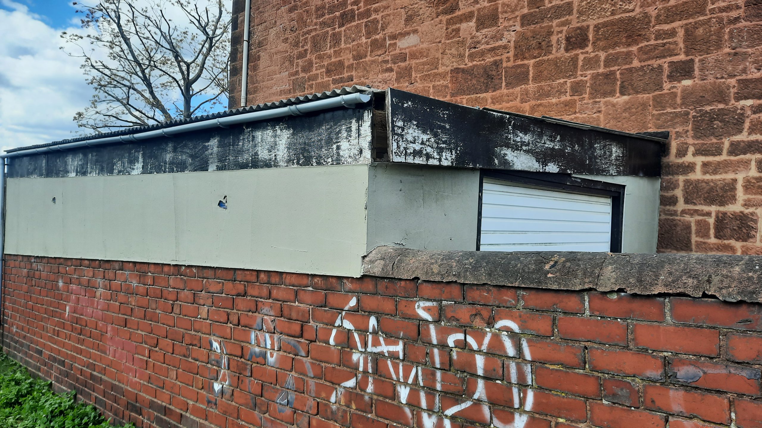 roughcaster Edinburgh working on patched garage exterior