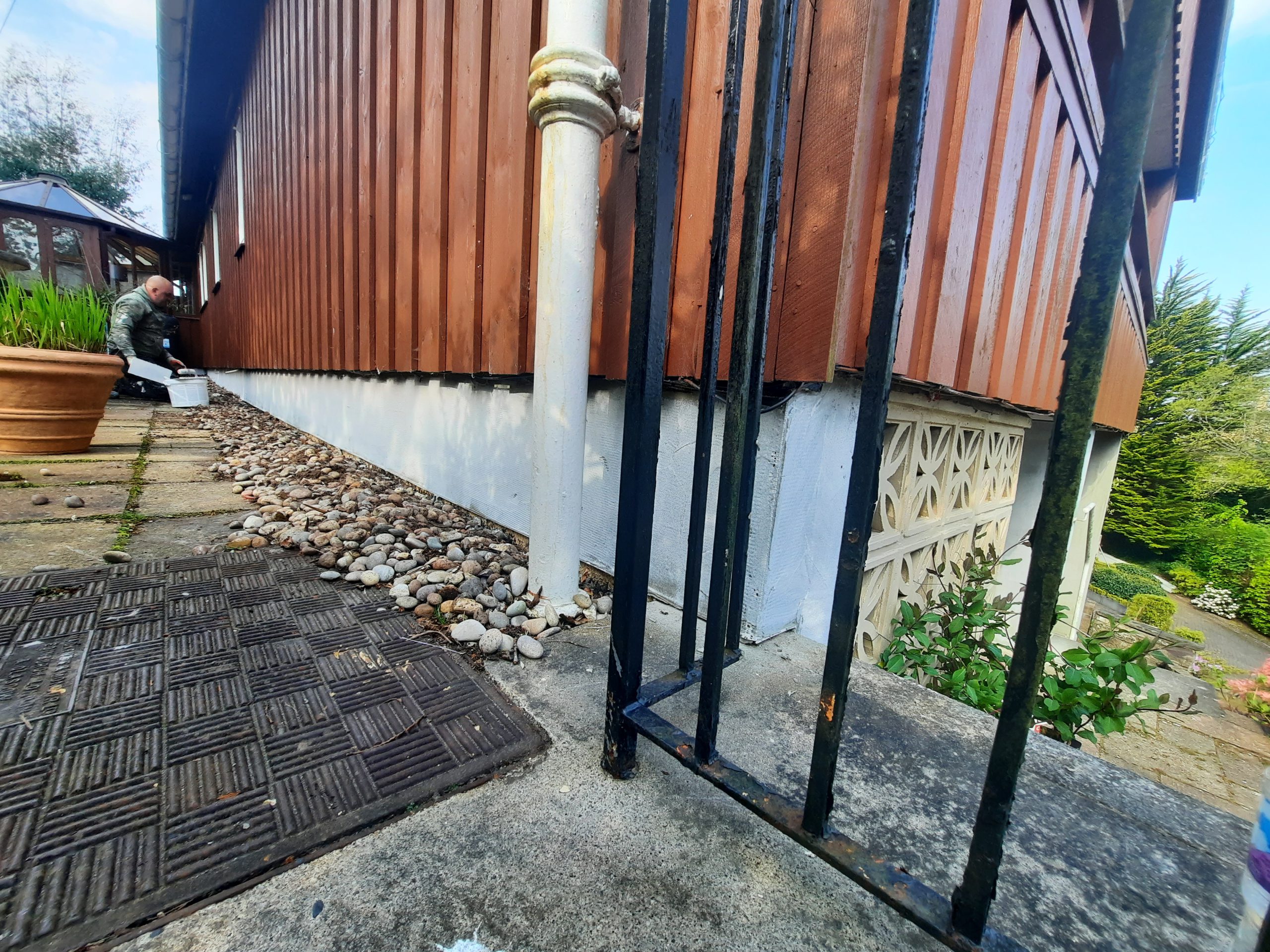 house rendering Edinburgh on wall behind metal gate