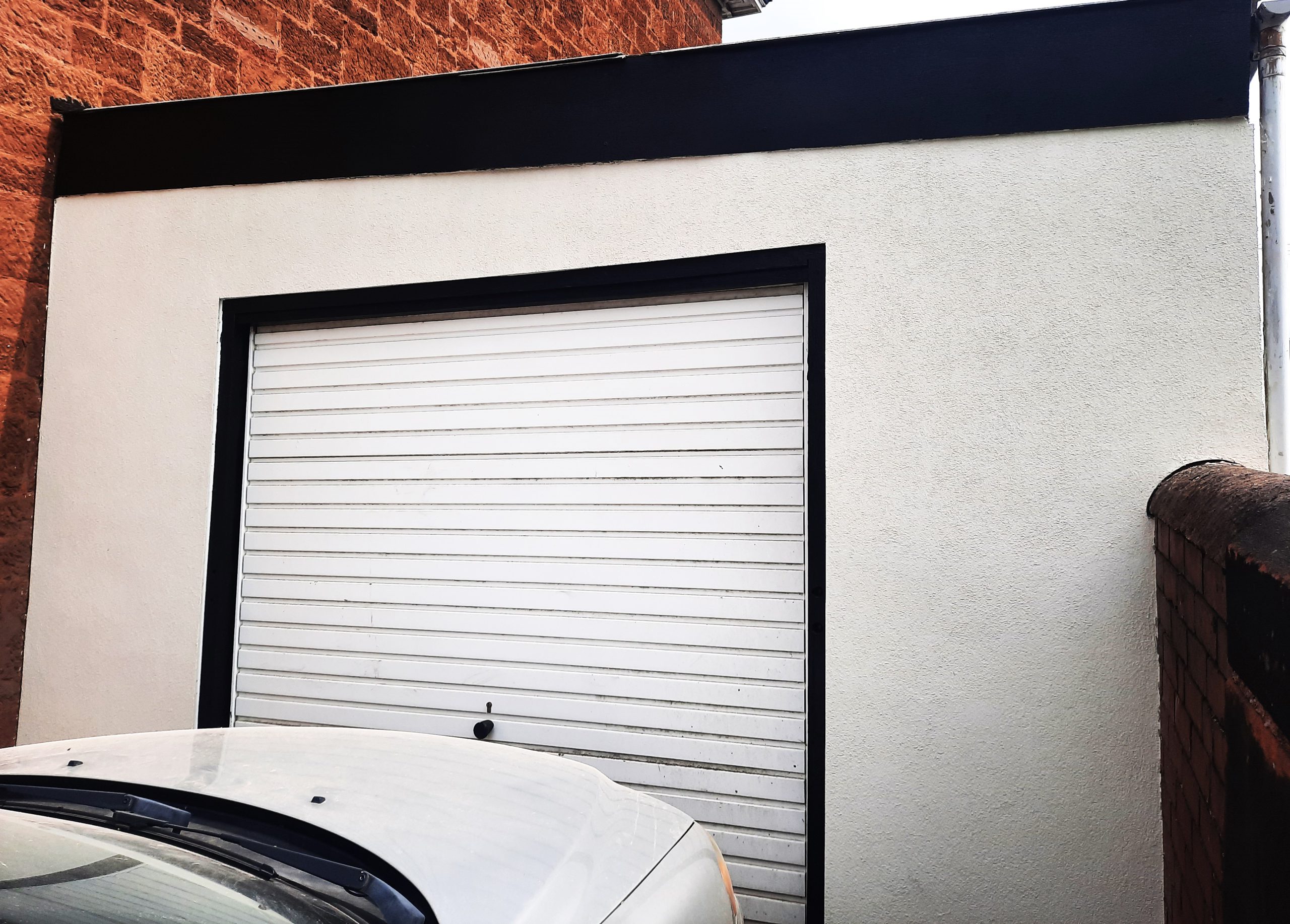 house rendering Edinburgh around white garage door frame