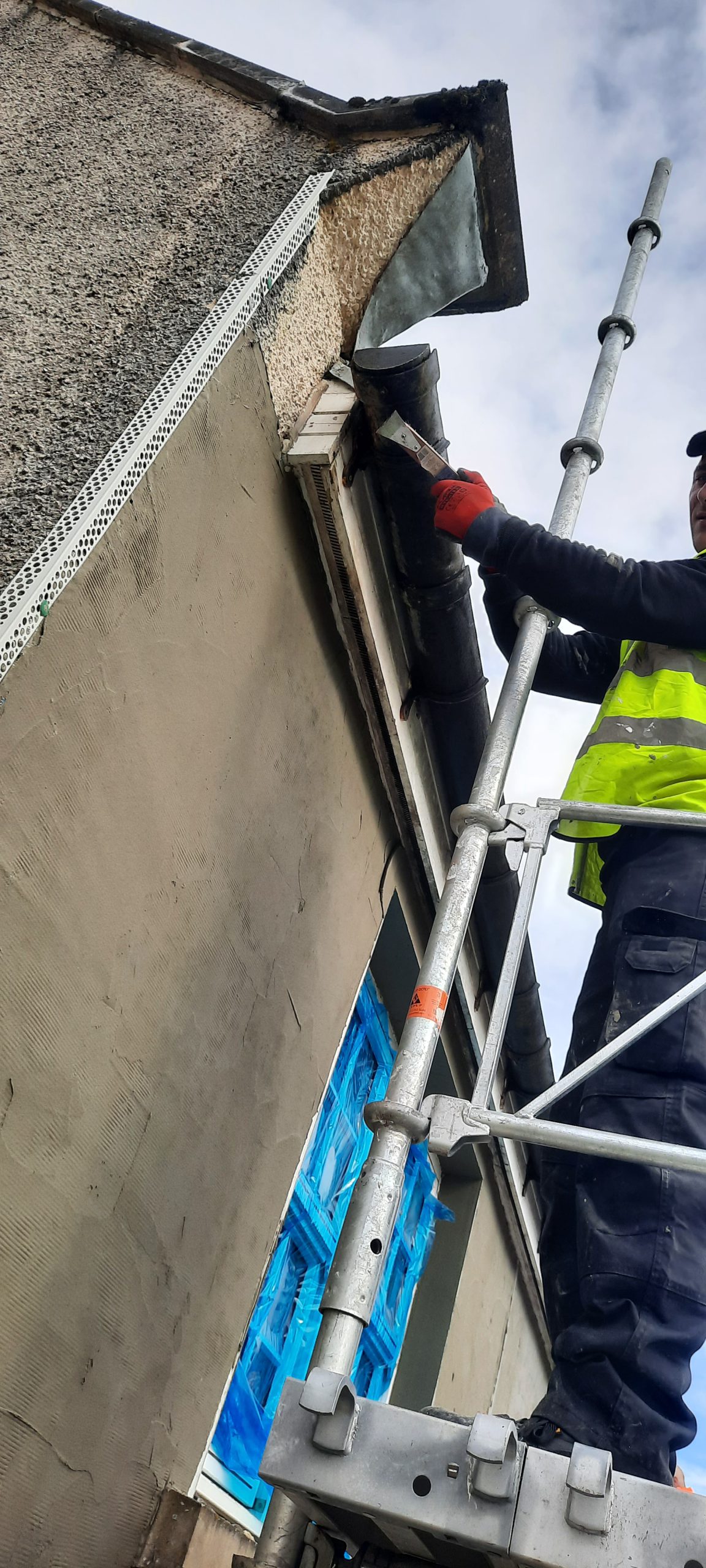 roughcasting Edinburgh applied by worker on scaffold