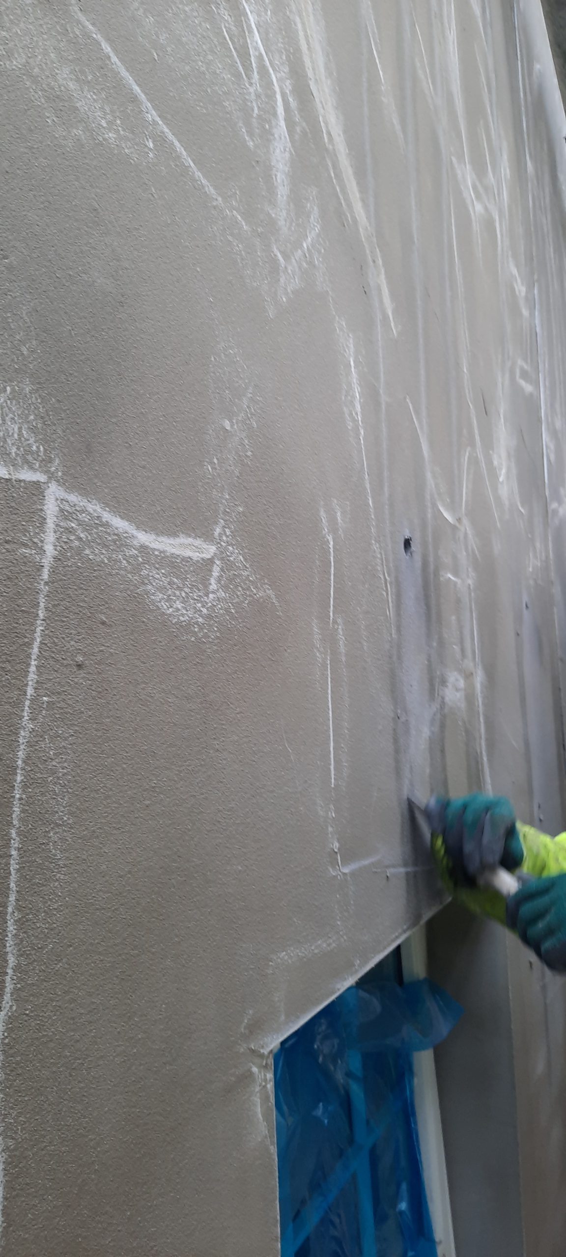 house rendering Edinburgh on corner wall with visible plaster layers