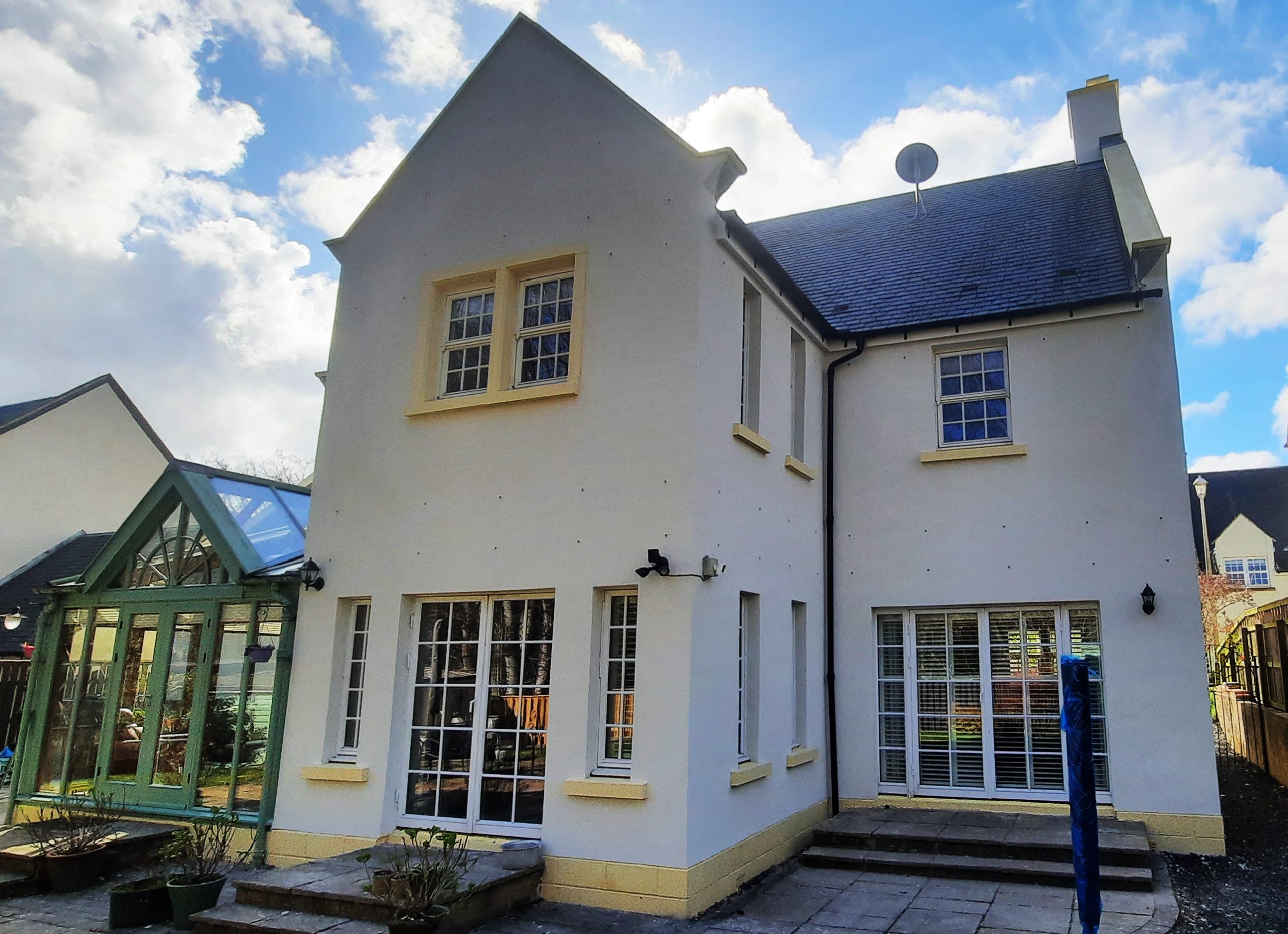 roughcast repair on house with yellow base trim