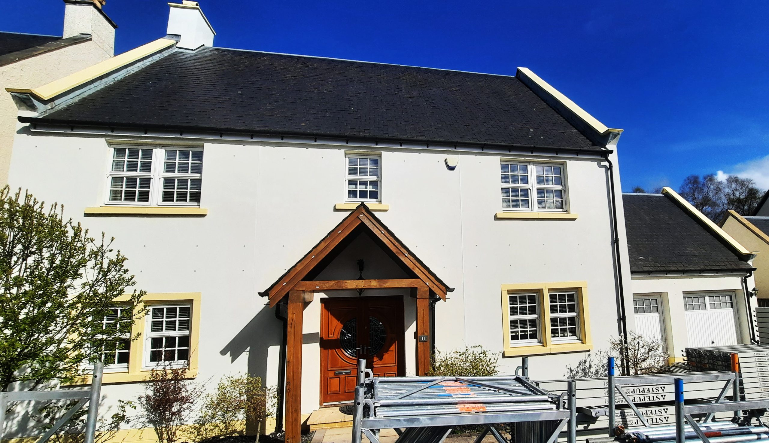roughcast render Edinburgh on front façade with wooden porch