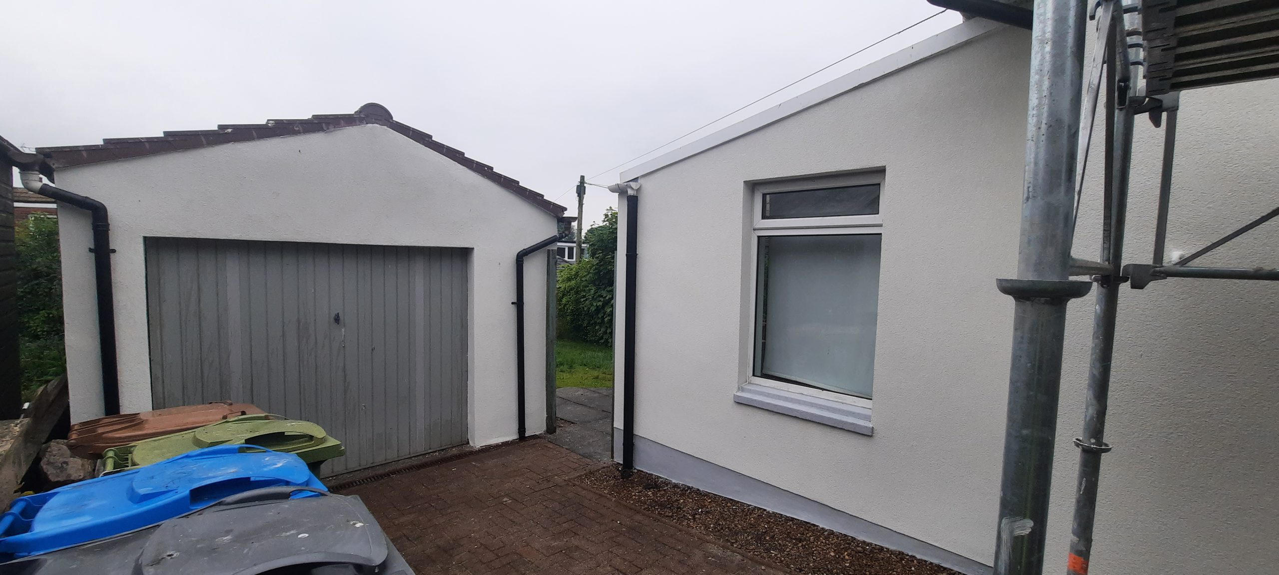 roughcast repair beside single garage door