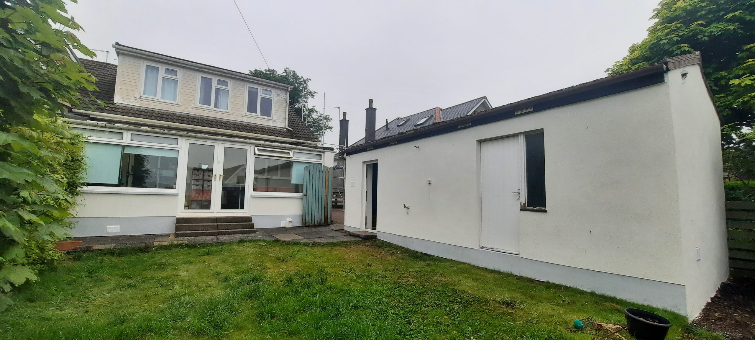 roughcast render repair on long rear garden wall