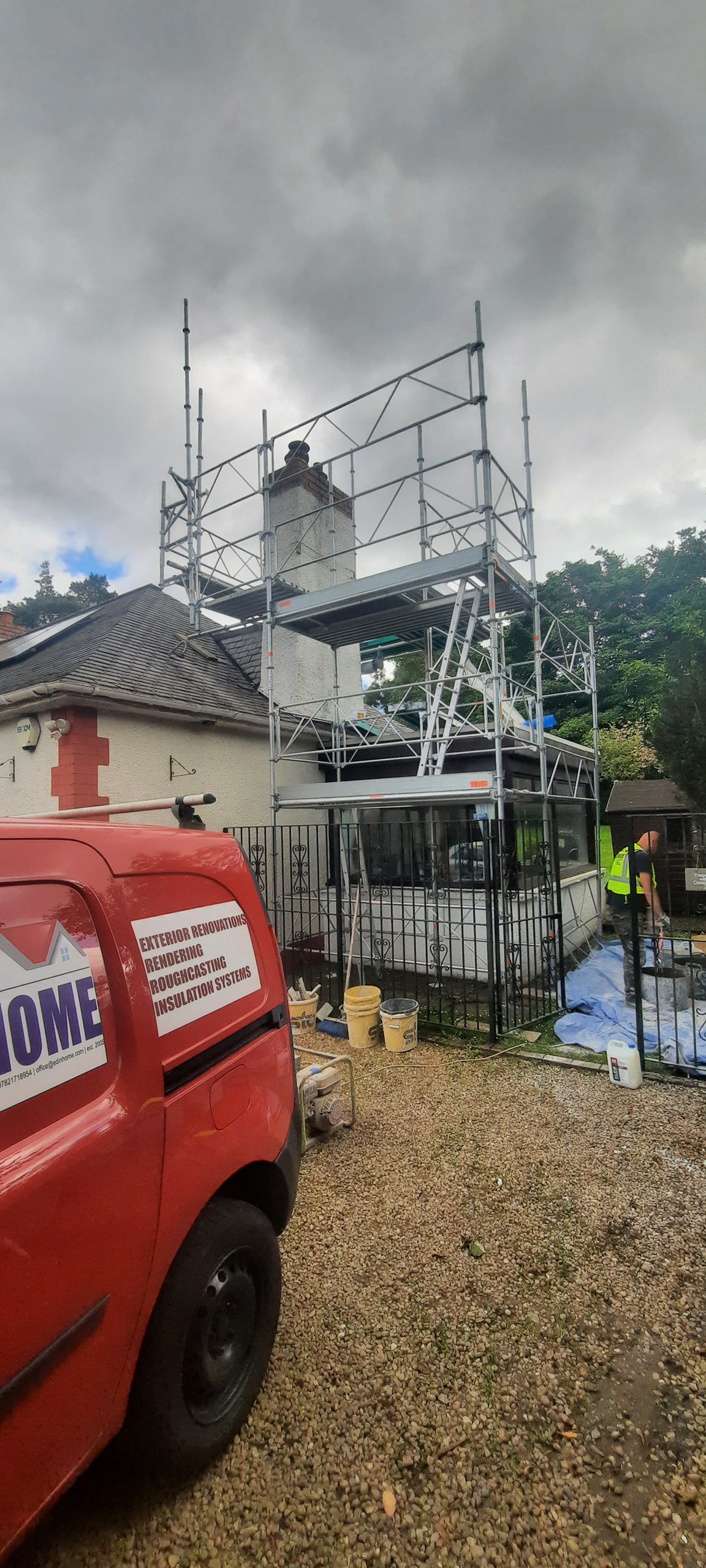 roughcast repair on house chimney under scaffolding