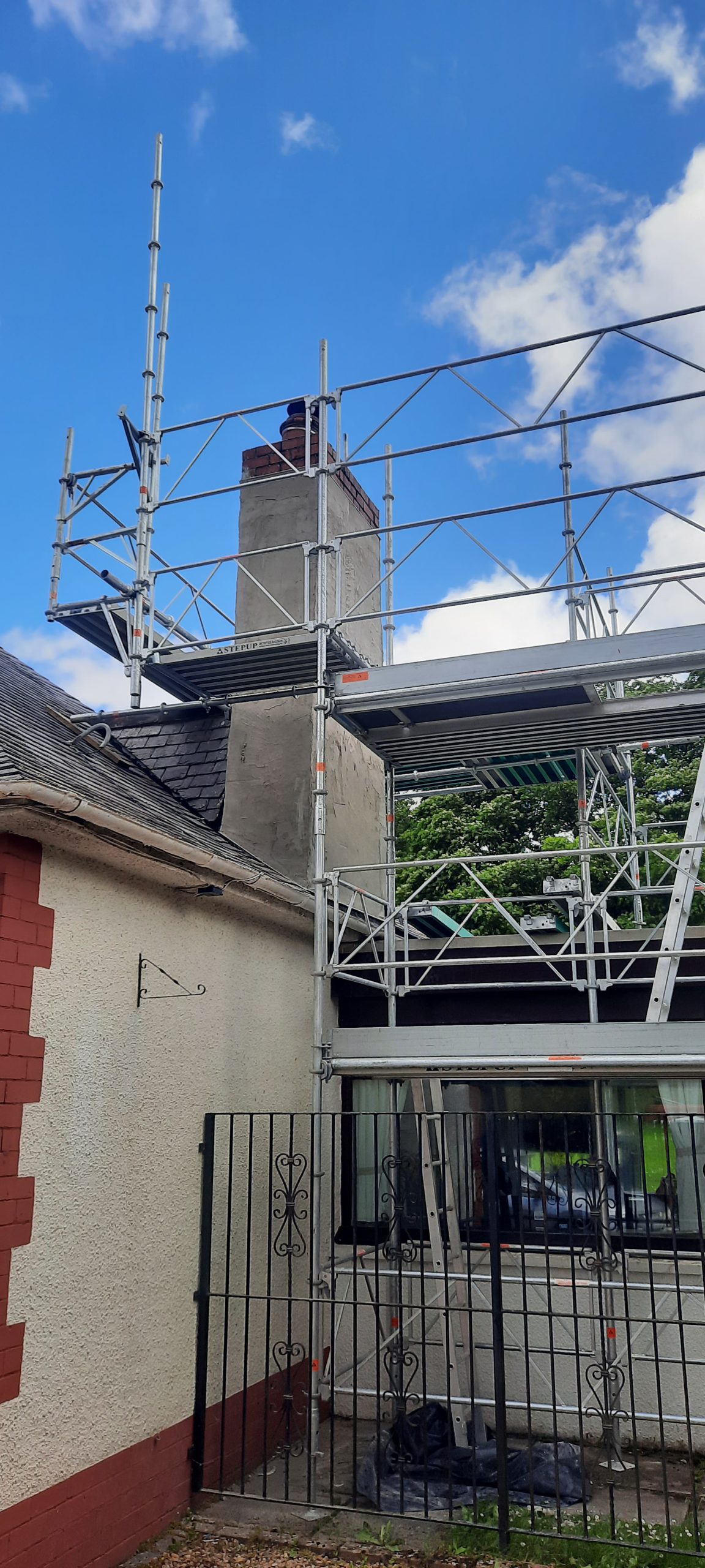 roughcast render Edinburgh applied to tall chimney section