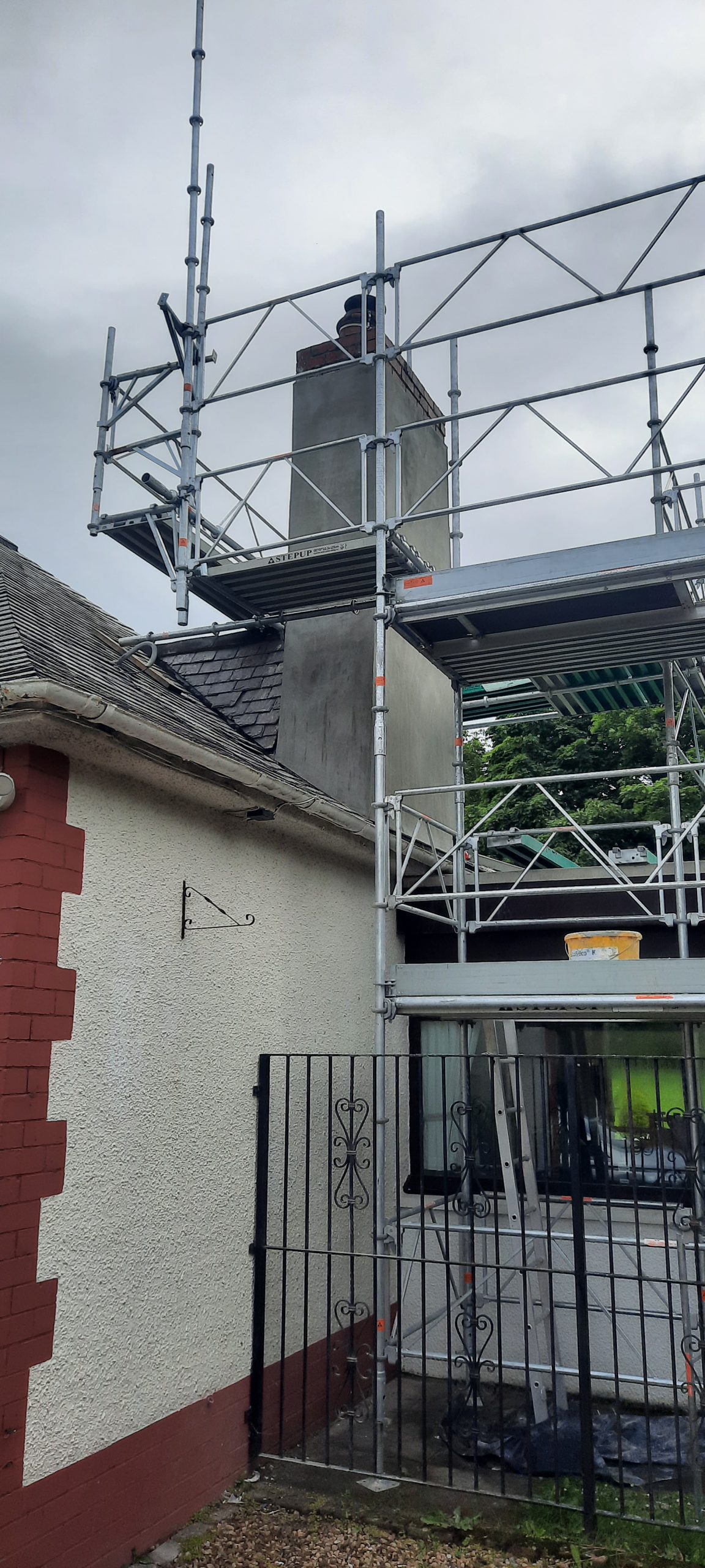 roughcasting Edinburgh on scaffolded chimney wall