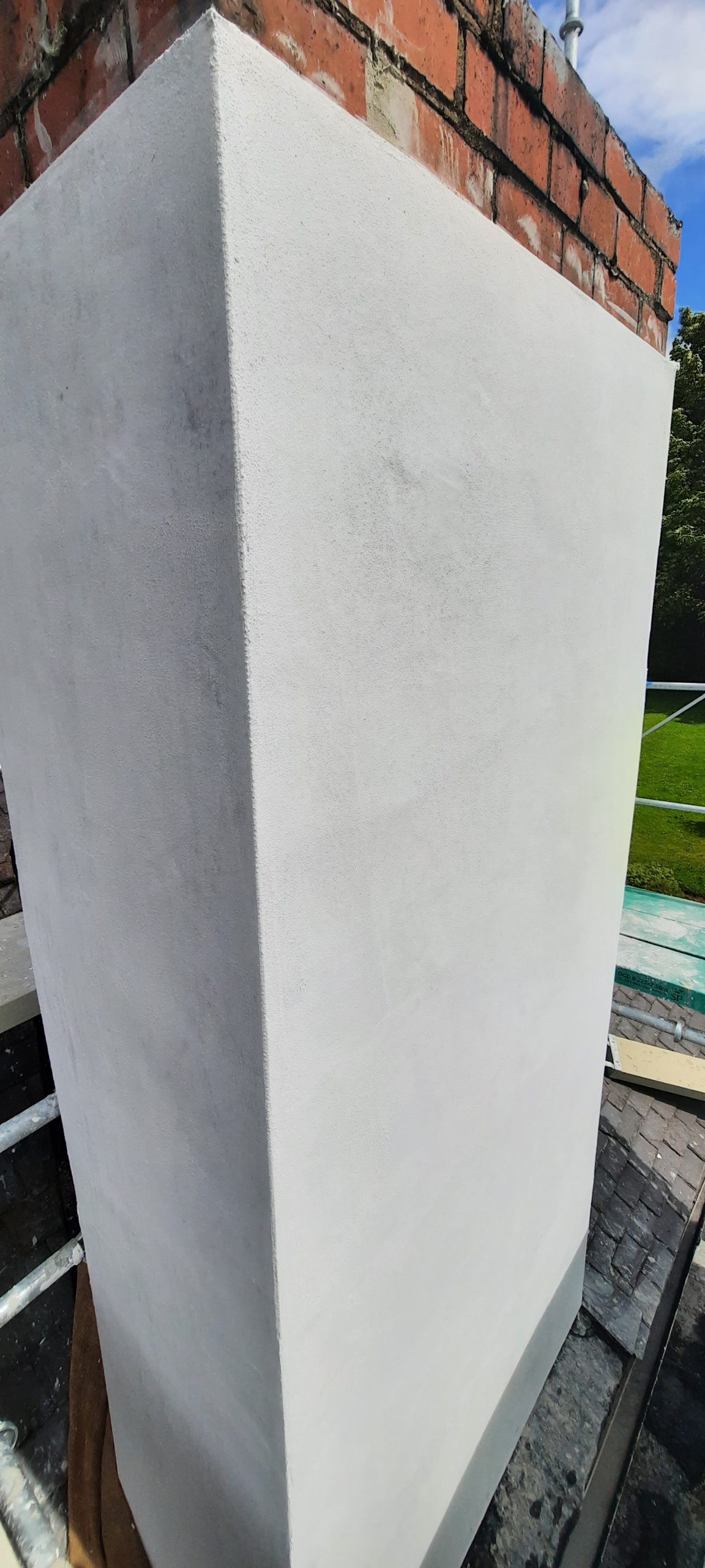 roughcast render repair to upper chimney section