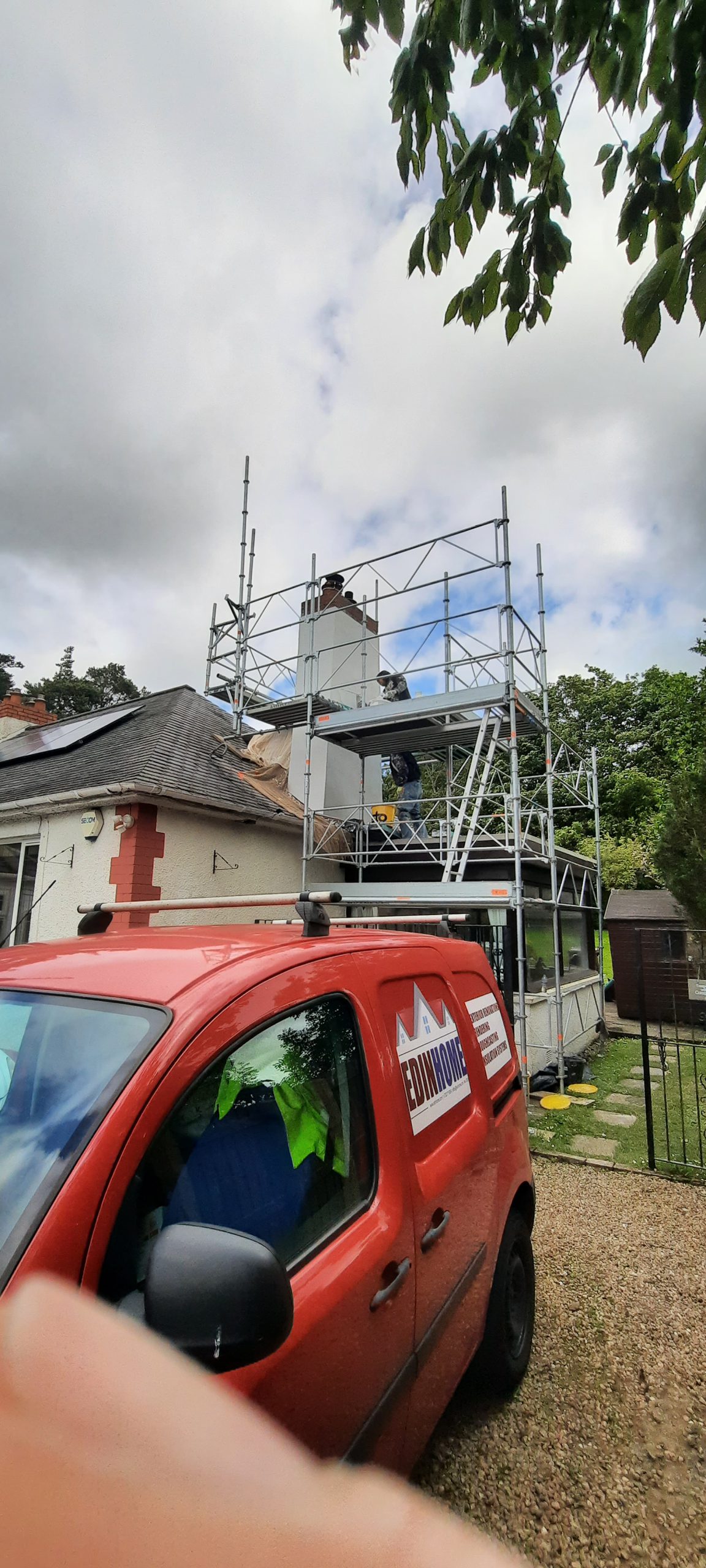 roughcaster Edinburgh working on scaffold near chimney