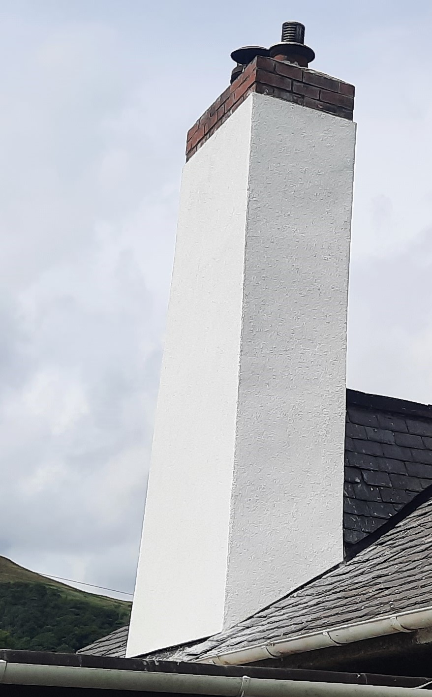roughcast render repair with smooth white finish on chimney