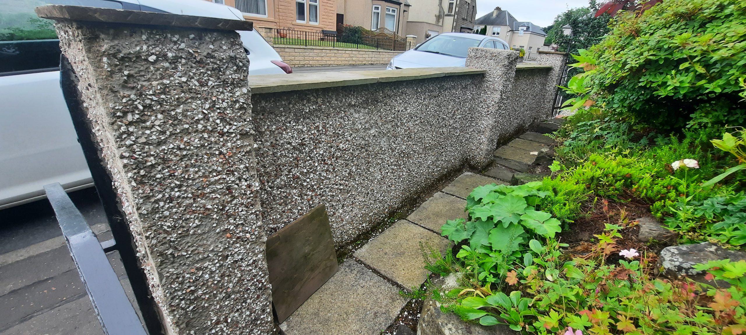 roughcast repair applied to full length of garden wall