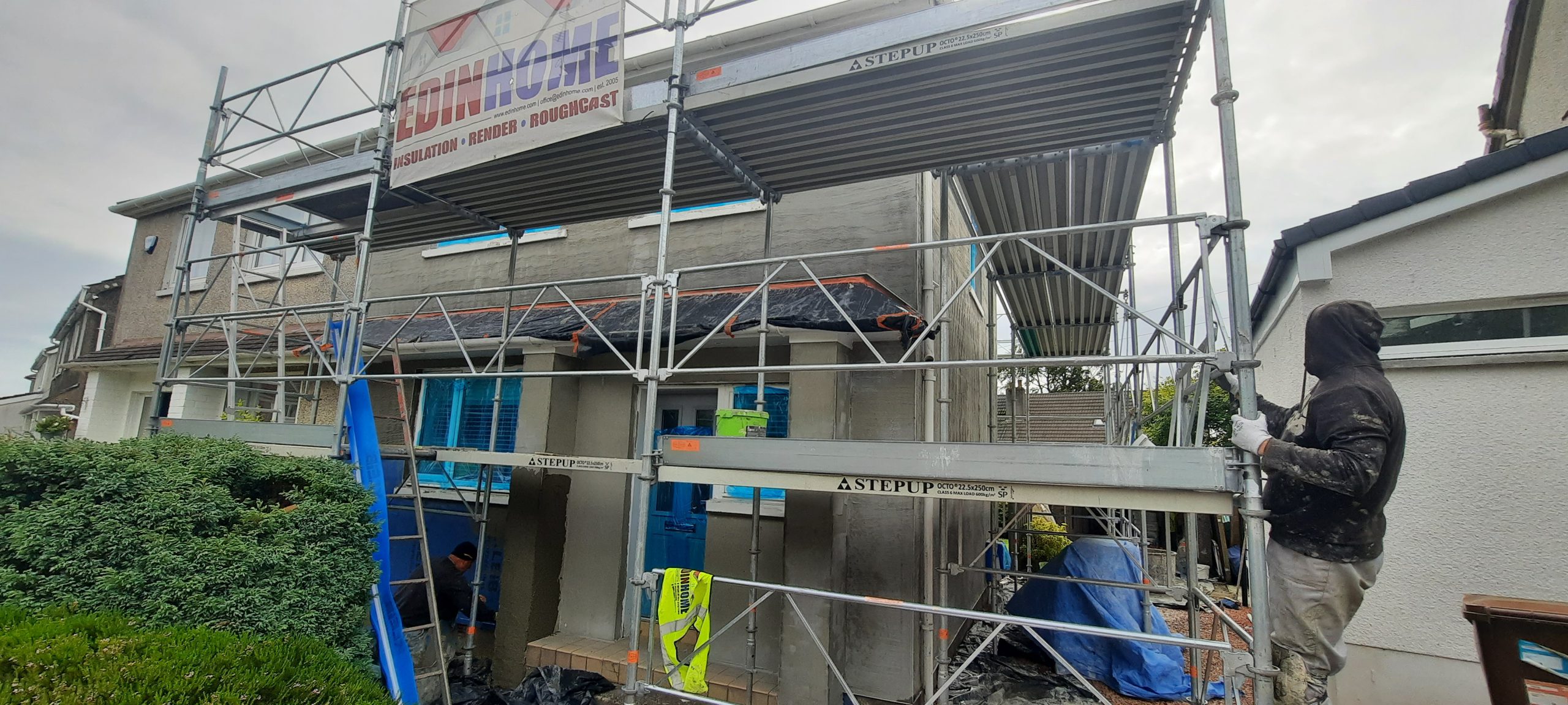 roughcast repair mid-application on lower façade