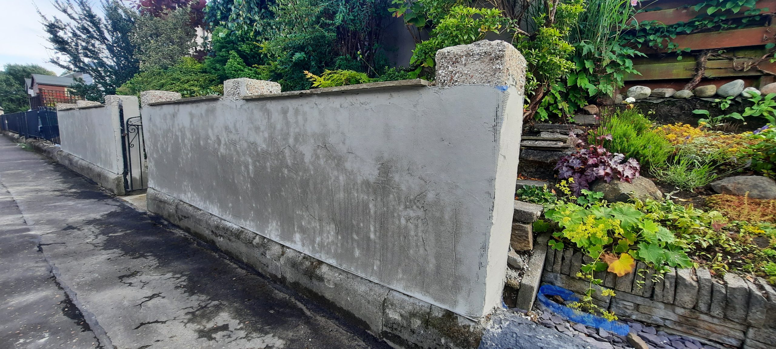 roughcast render repair newly coated on grey wall
