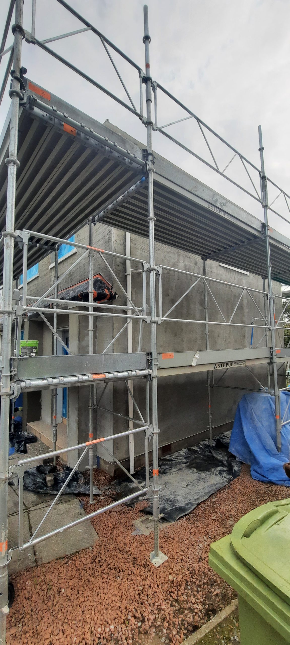 roughcast render repair in scaffolded housing project