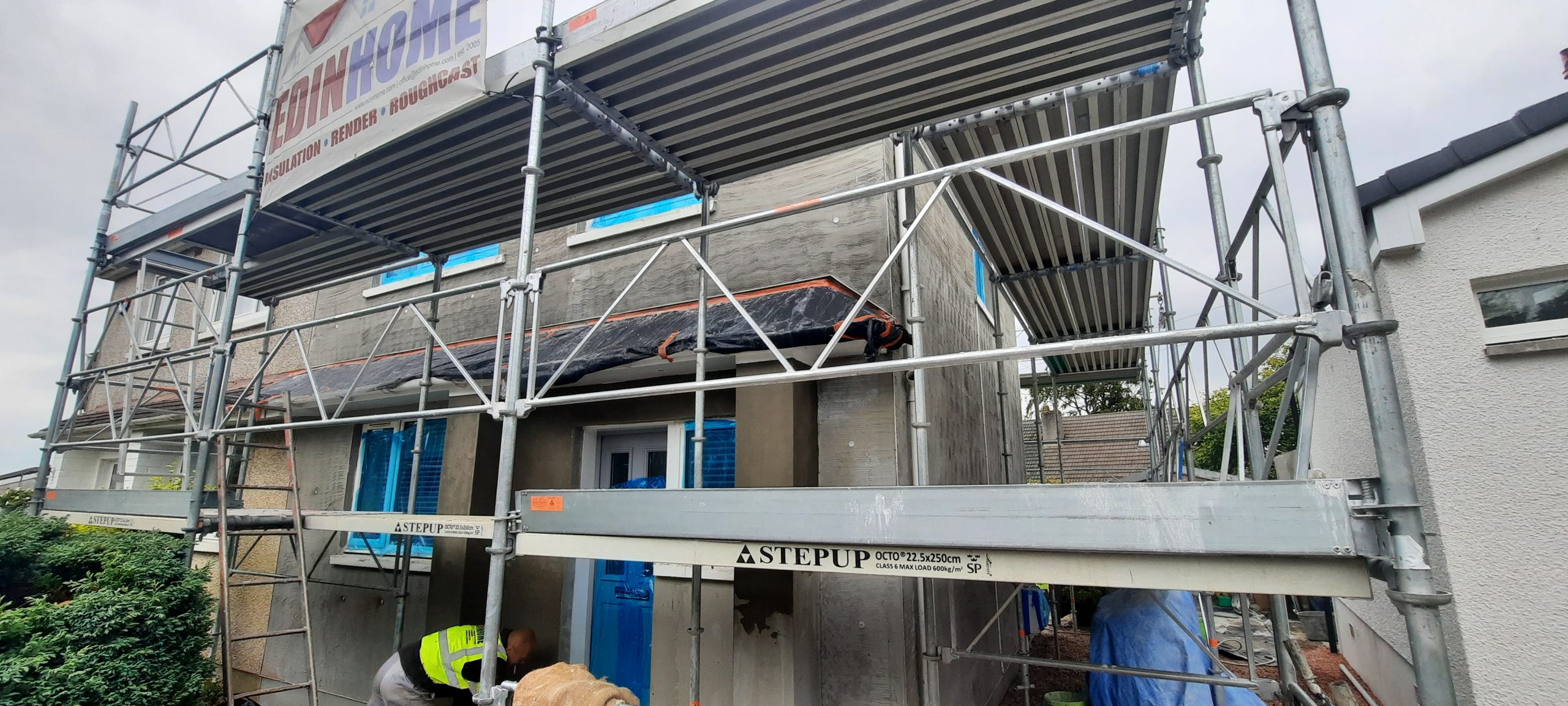 roughcast render Edinburgh part-applied above doorway