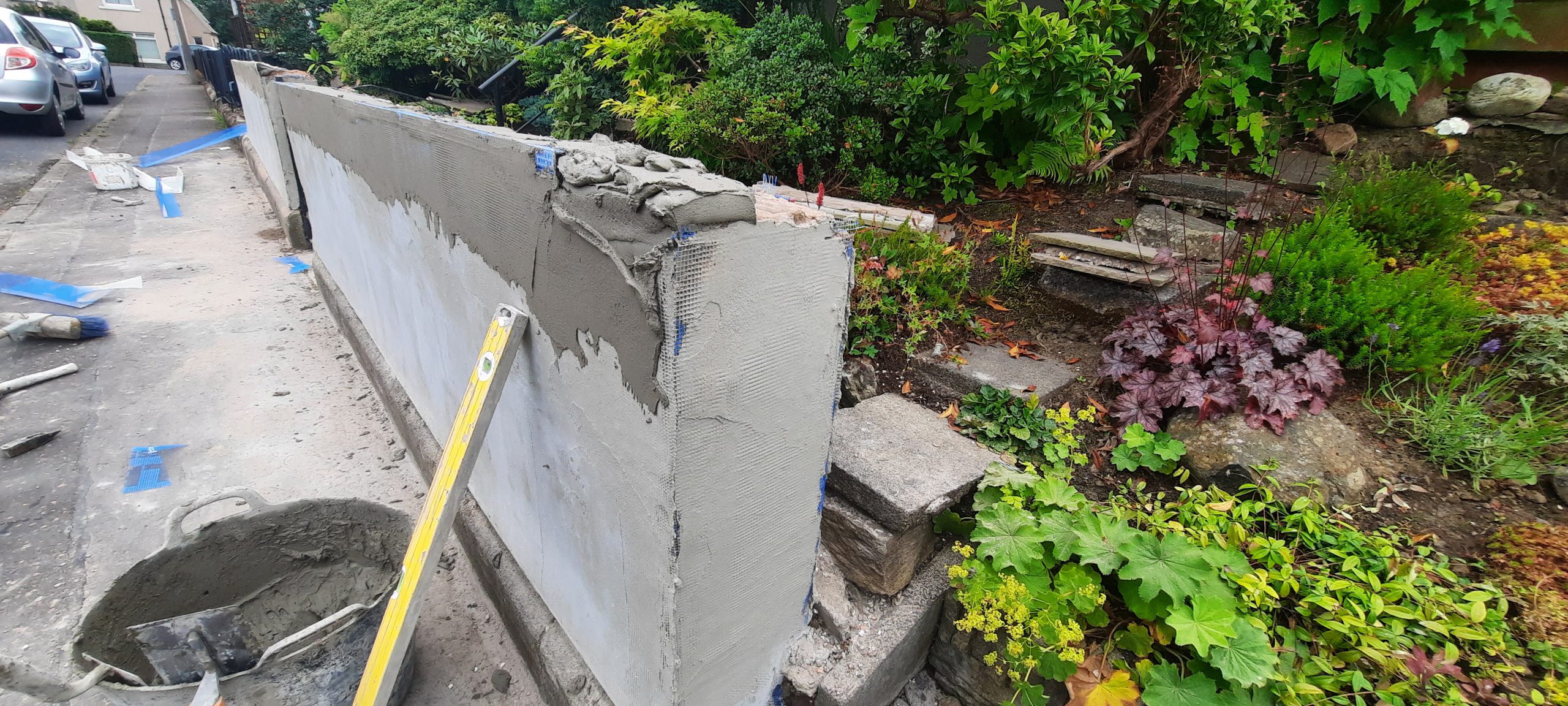 roughcast render repair to damaged top of garden wall