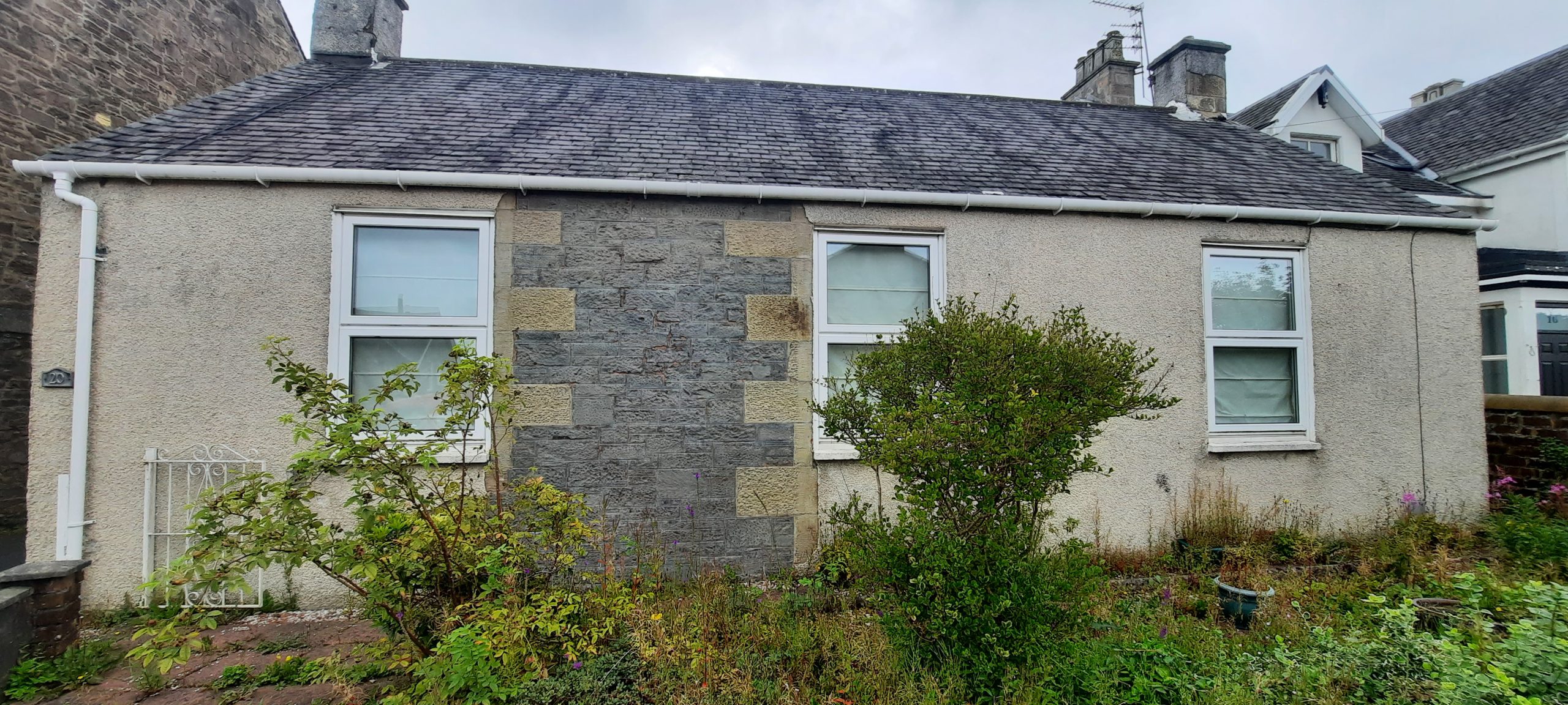 roughcast repair beside stone and render mix wall