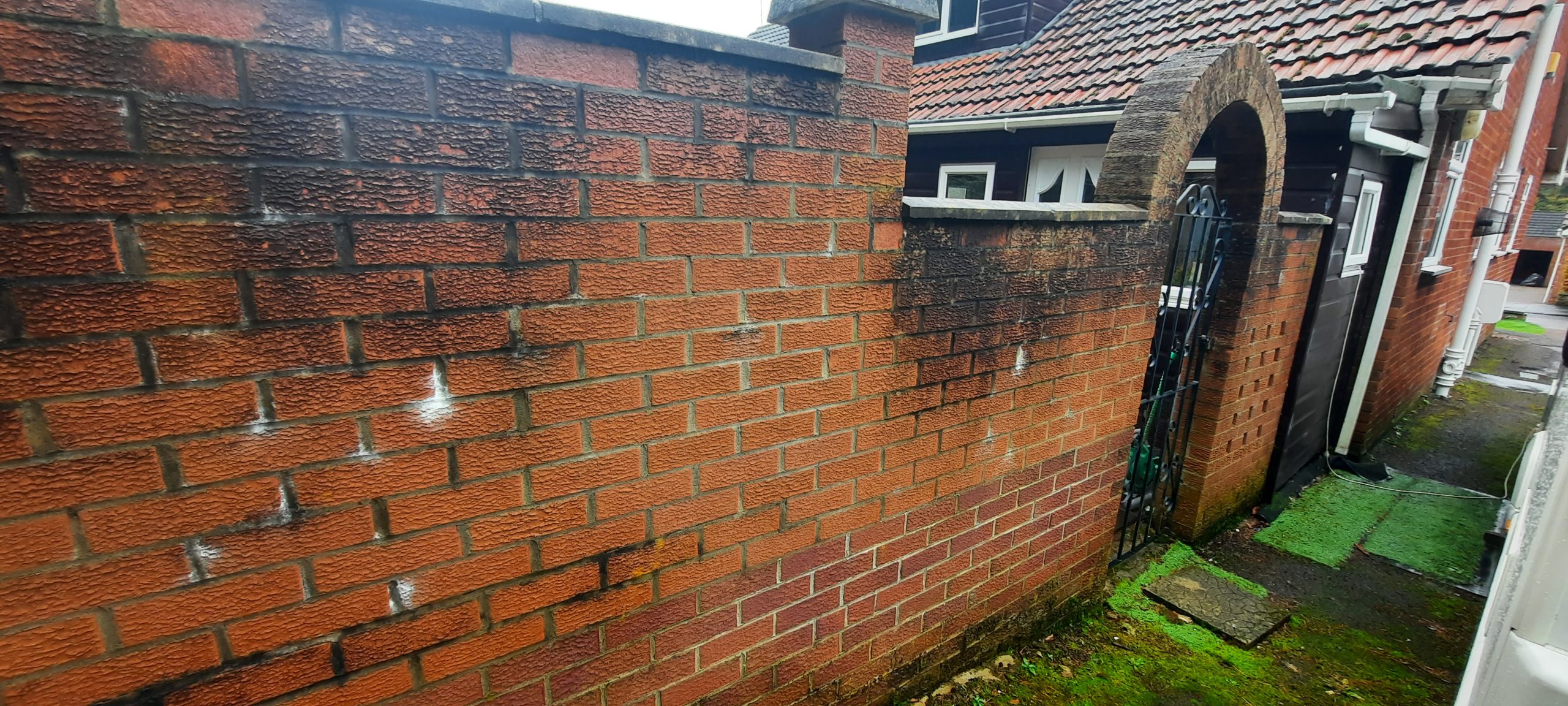 roughcast render repair on old brick garden wall