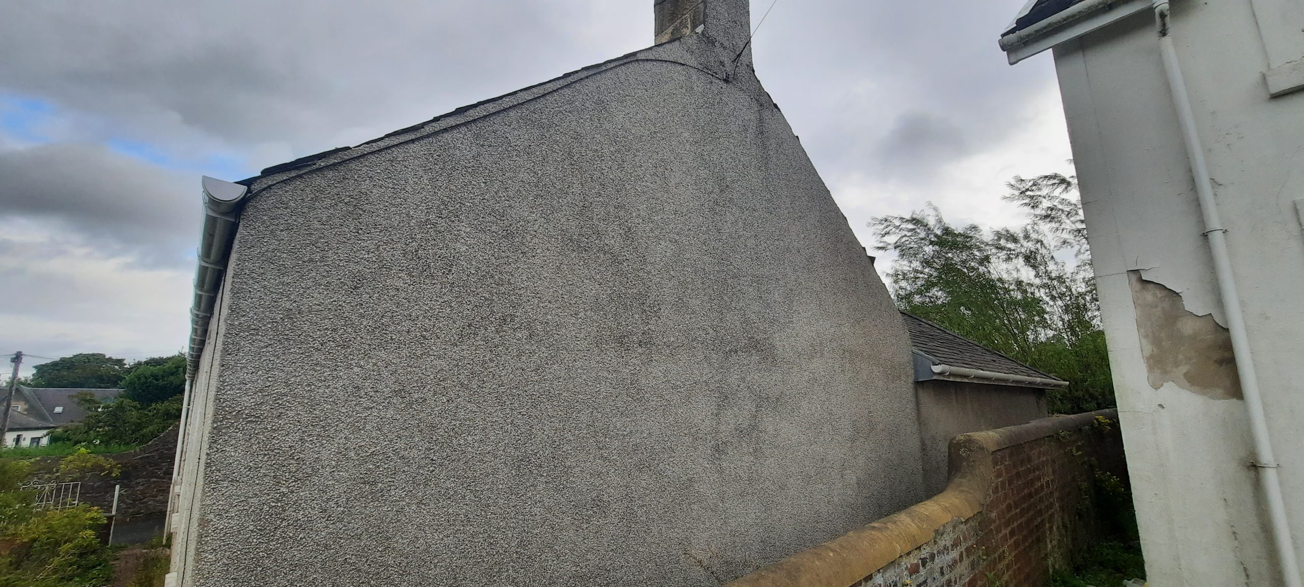 roughcaster Edinburgh working on tall gable end