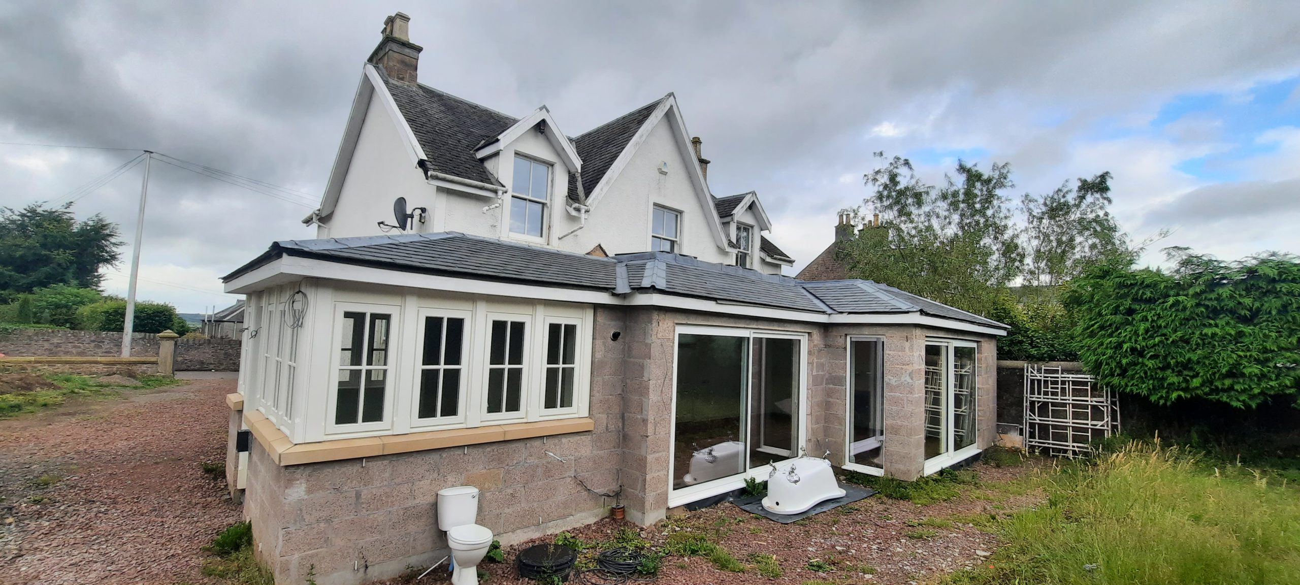 roughcast render Edinburgh beside conservatory extension