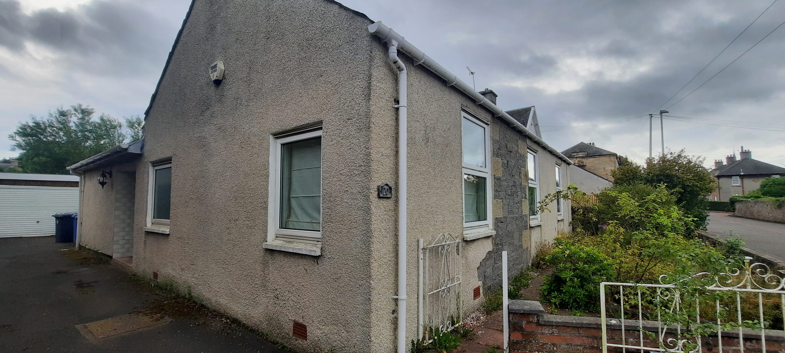roughcasting Edinburgh on narrow side wall of home