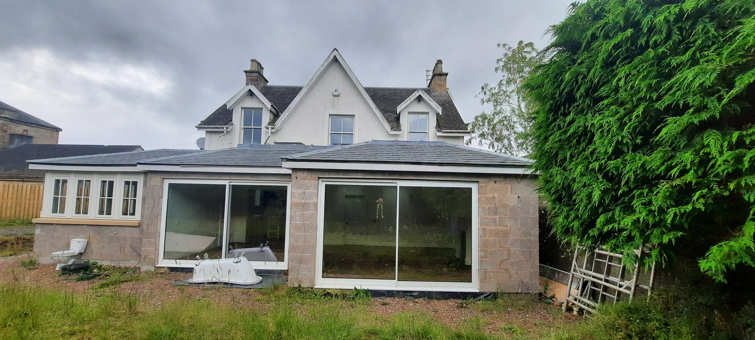 roughcast render repair on lower wall of period property