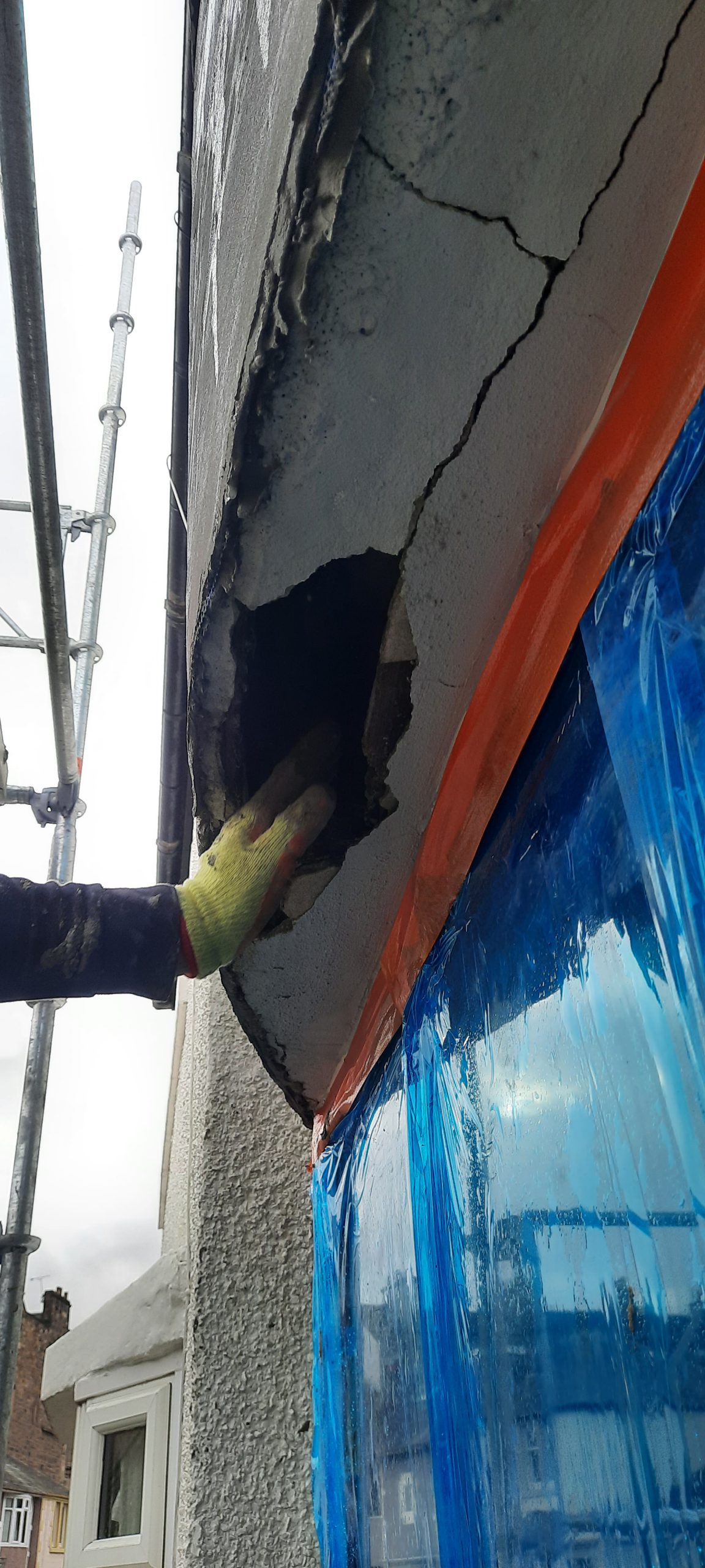 Rendering Edinburgh applied by worker with trowel
