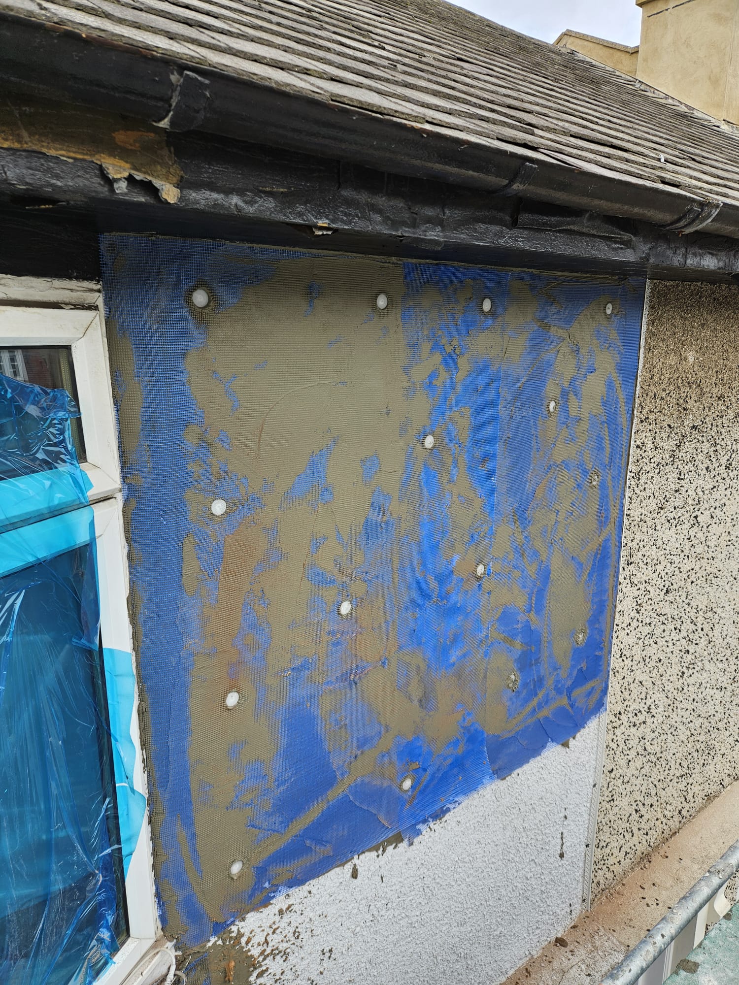 roughcast repair with fresh coat over blue masking