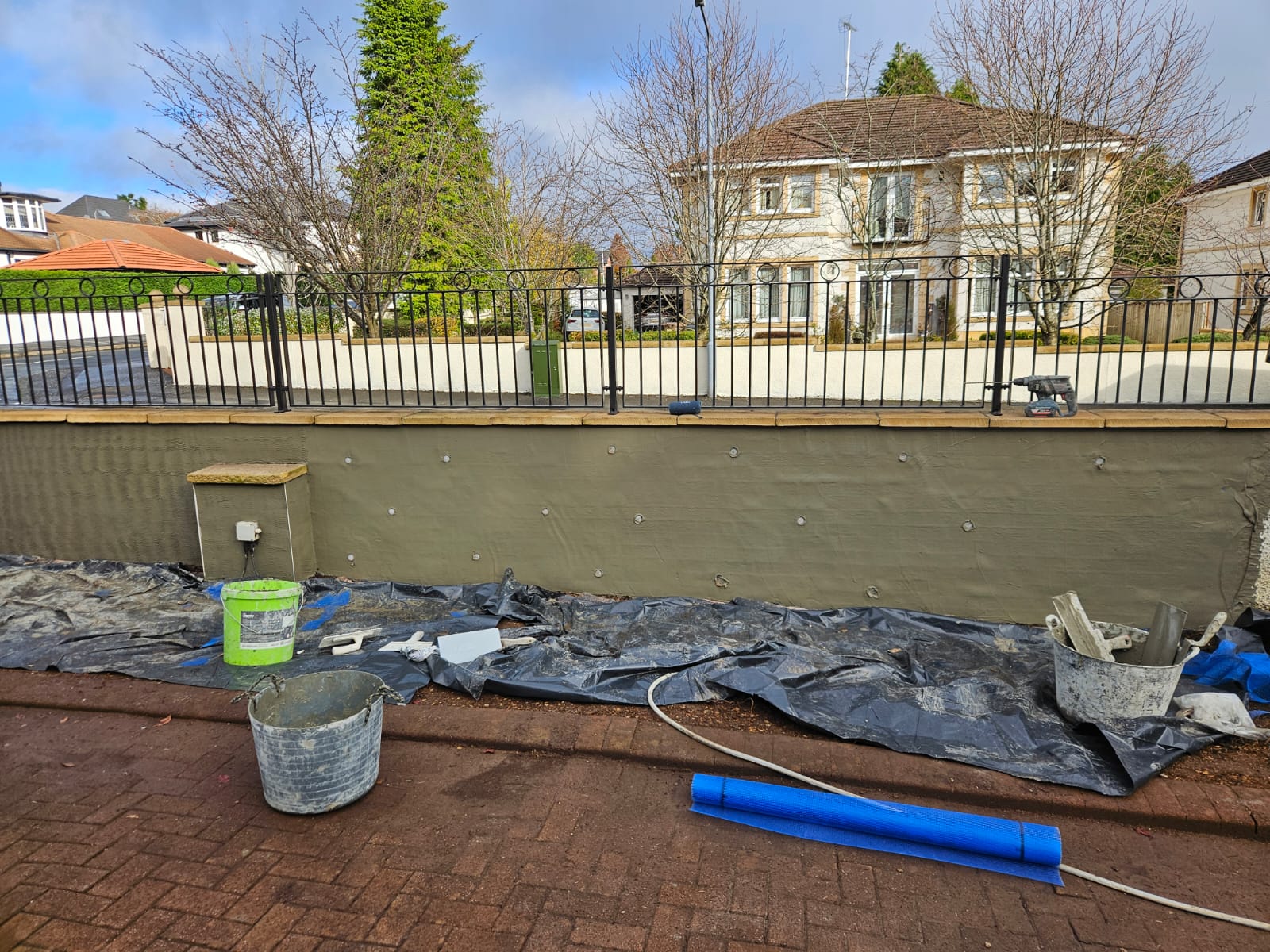 roughcast render repair with smooth grey finish