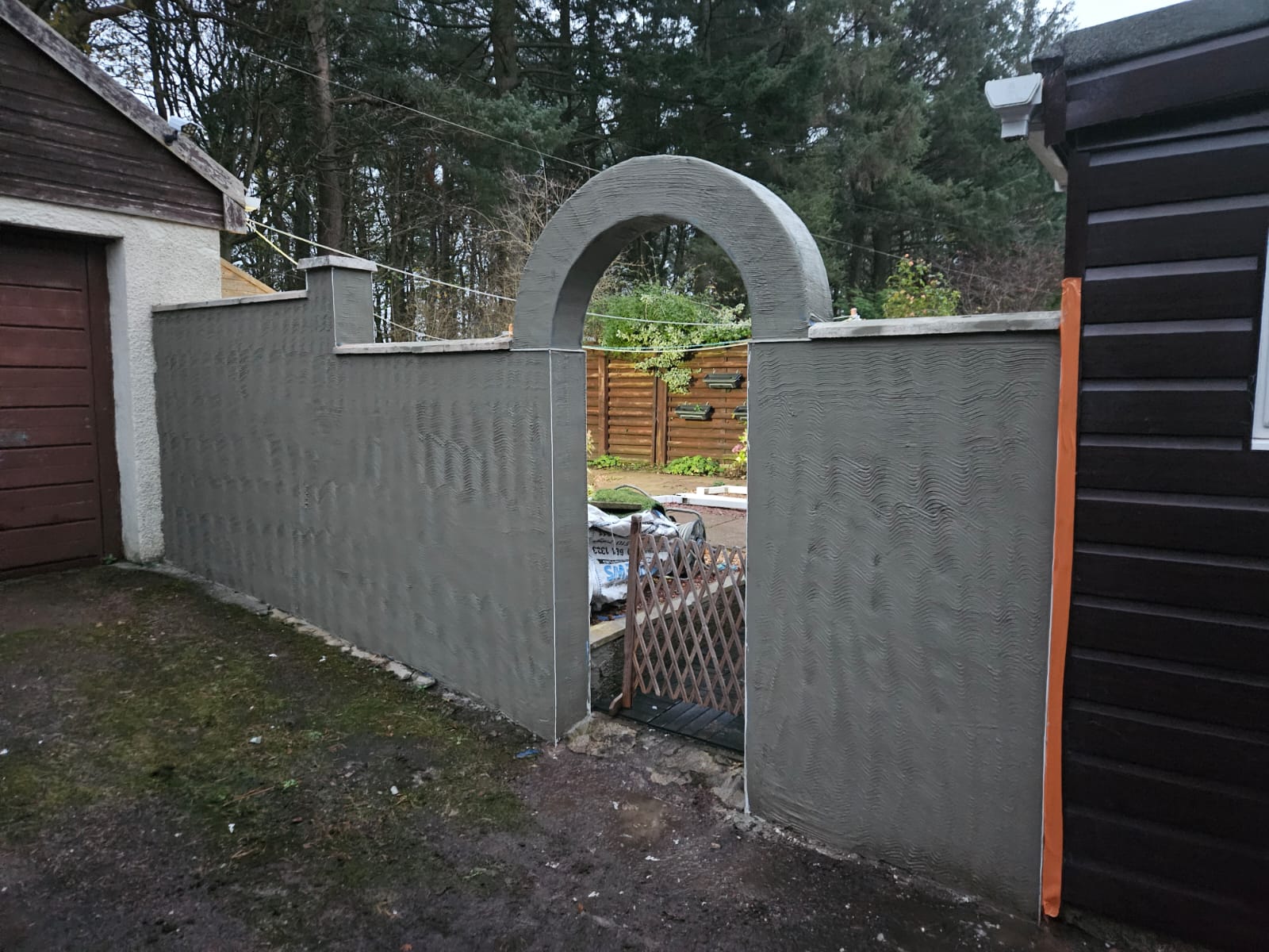 roughcasting Edinburgh on arched garden entrance wall