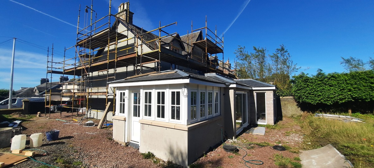 Rendering Edinburgh on conservatory wall under scaffold