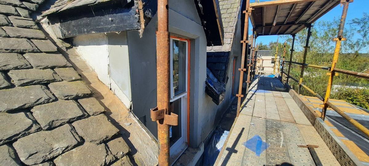 roughcast repair near roofline with timber support