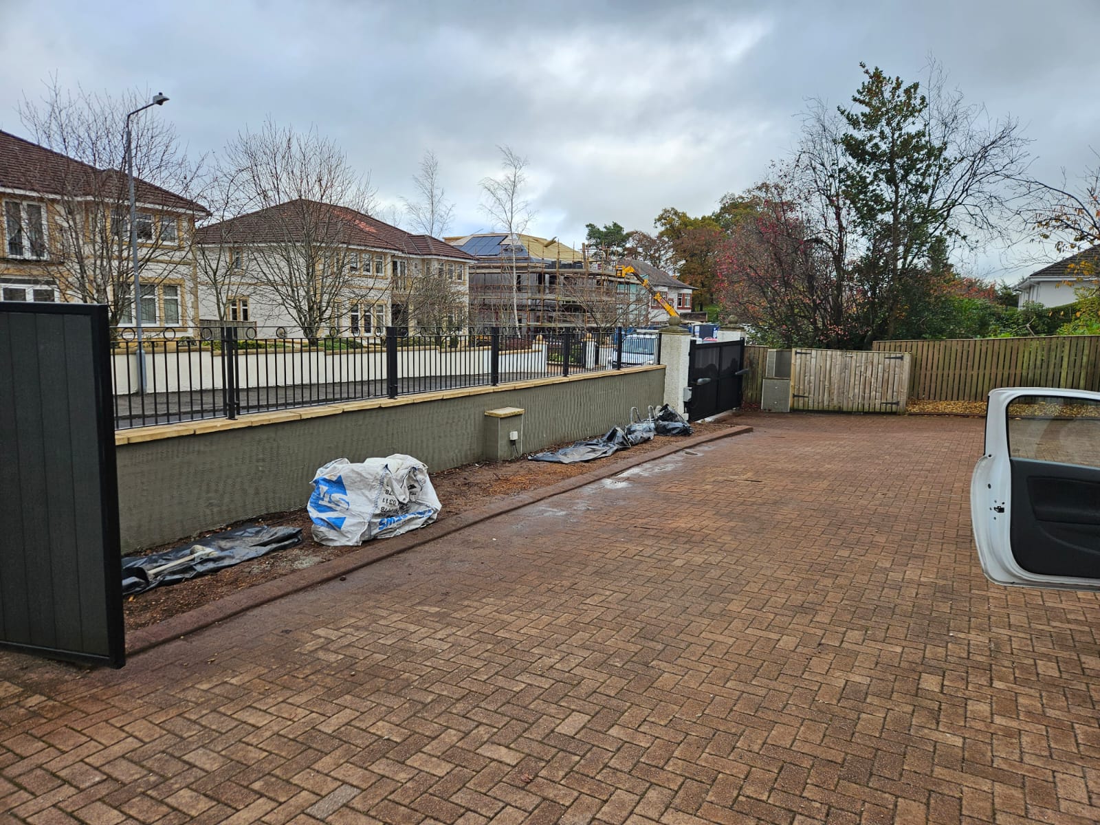 roughcast render repair across long front boundary wall