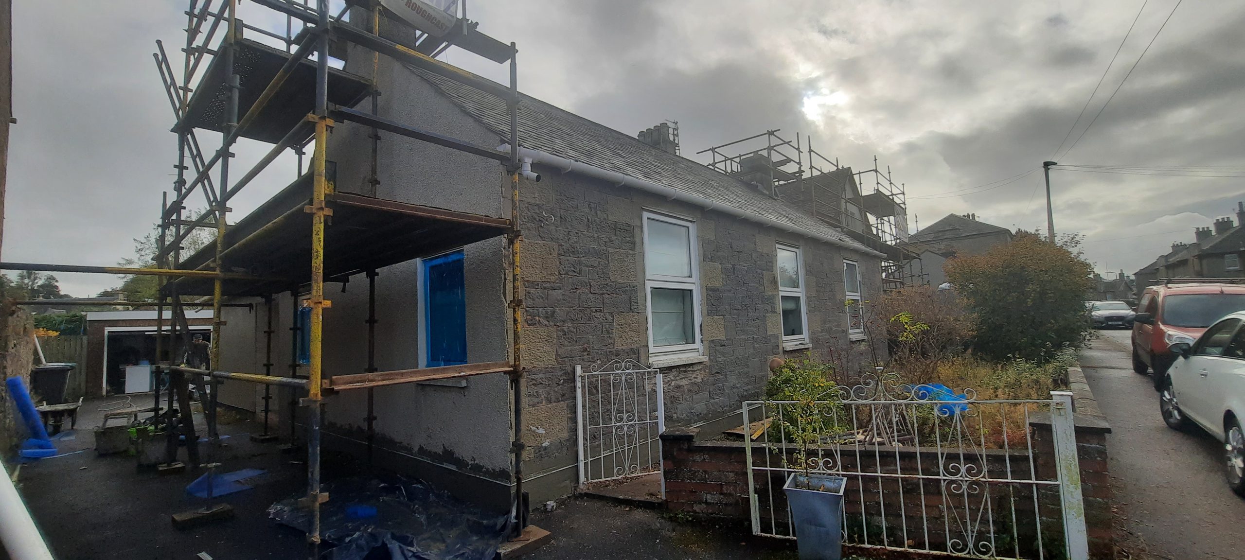 roughcast render repair on bungalow front wall
