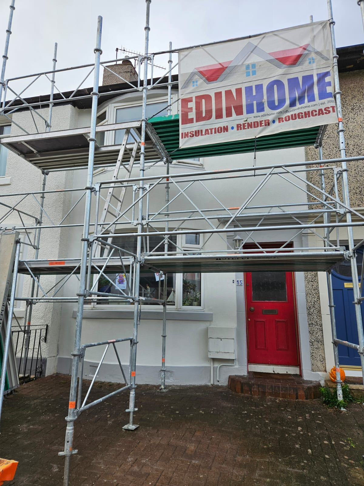 roughcast render repair on scaffolded front entrance