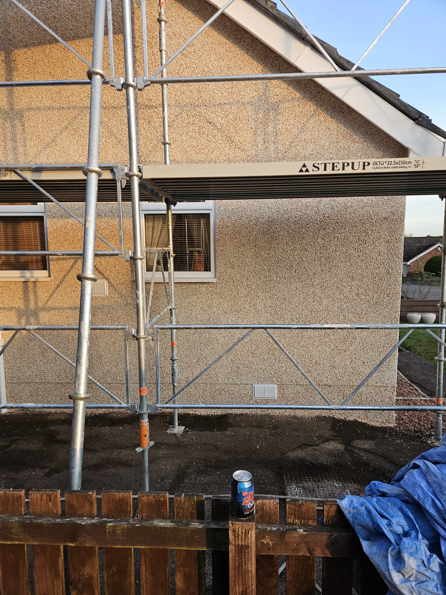 roughcast repair on side wall near roofline